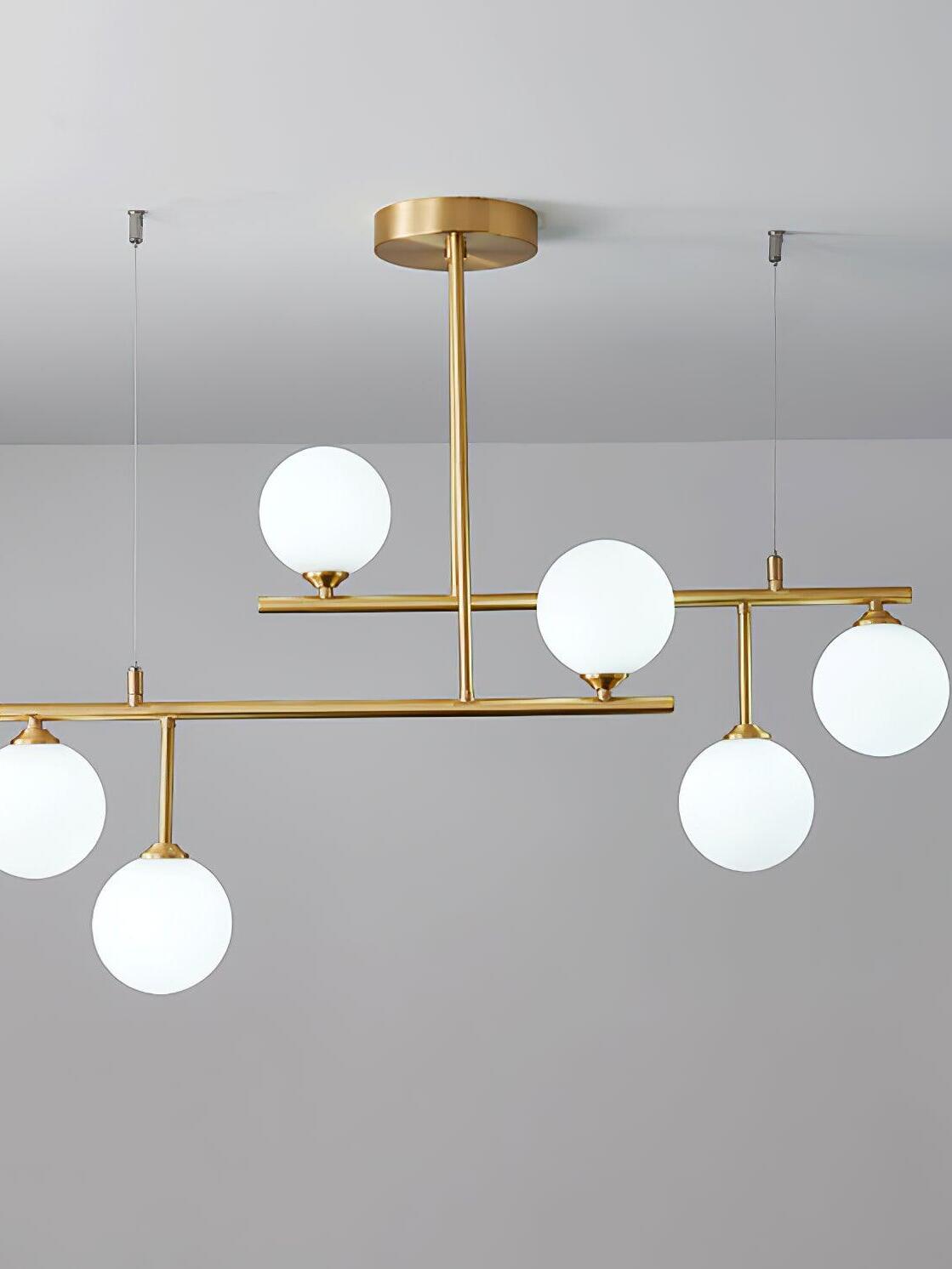 Arteriors six-globe chandelier with two staggered brass-tone bars, a round canopy and fine support wires