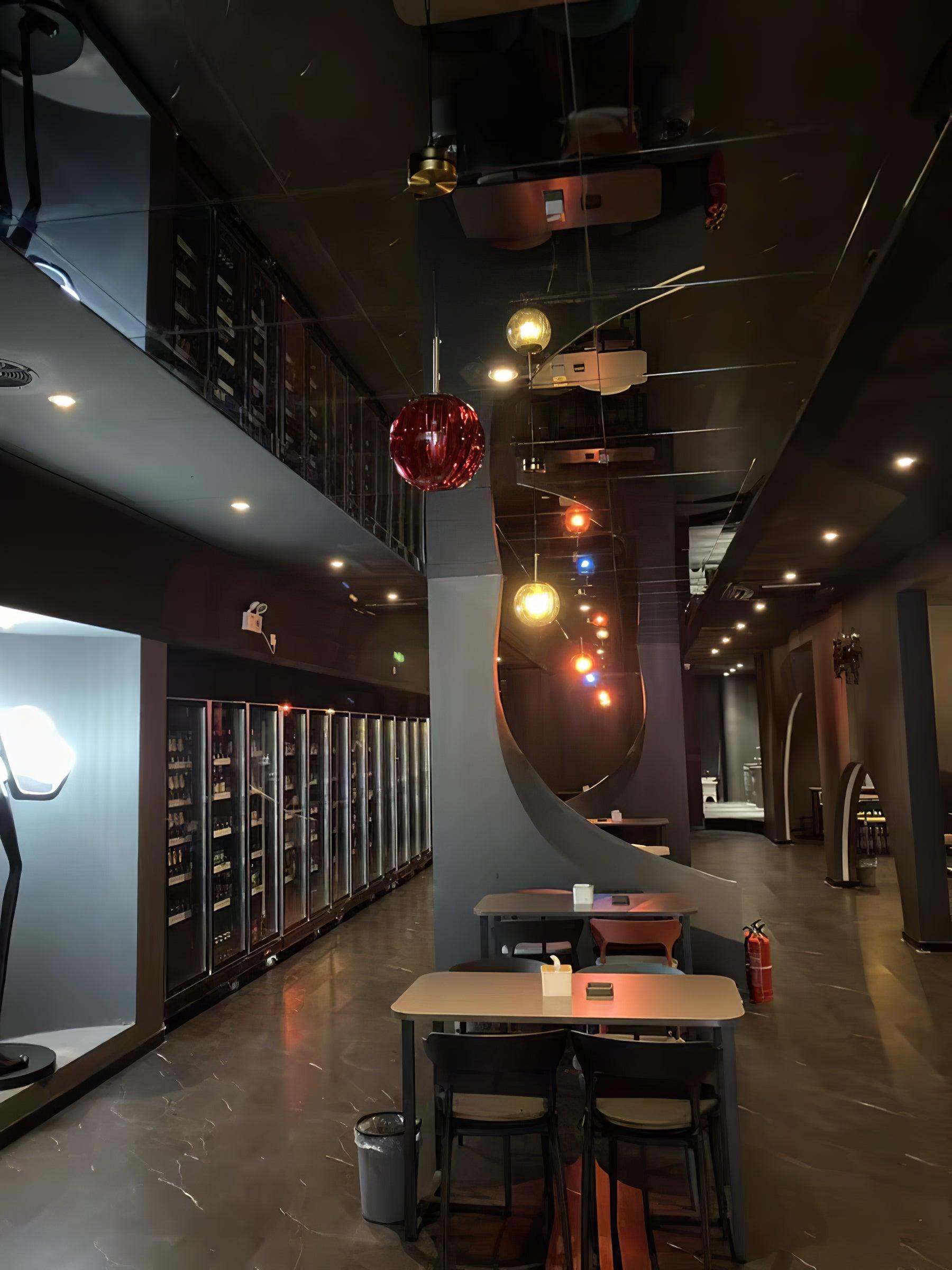 Coloured glass pendants above restaurant tables