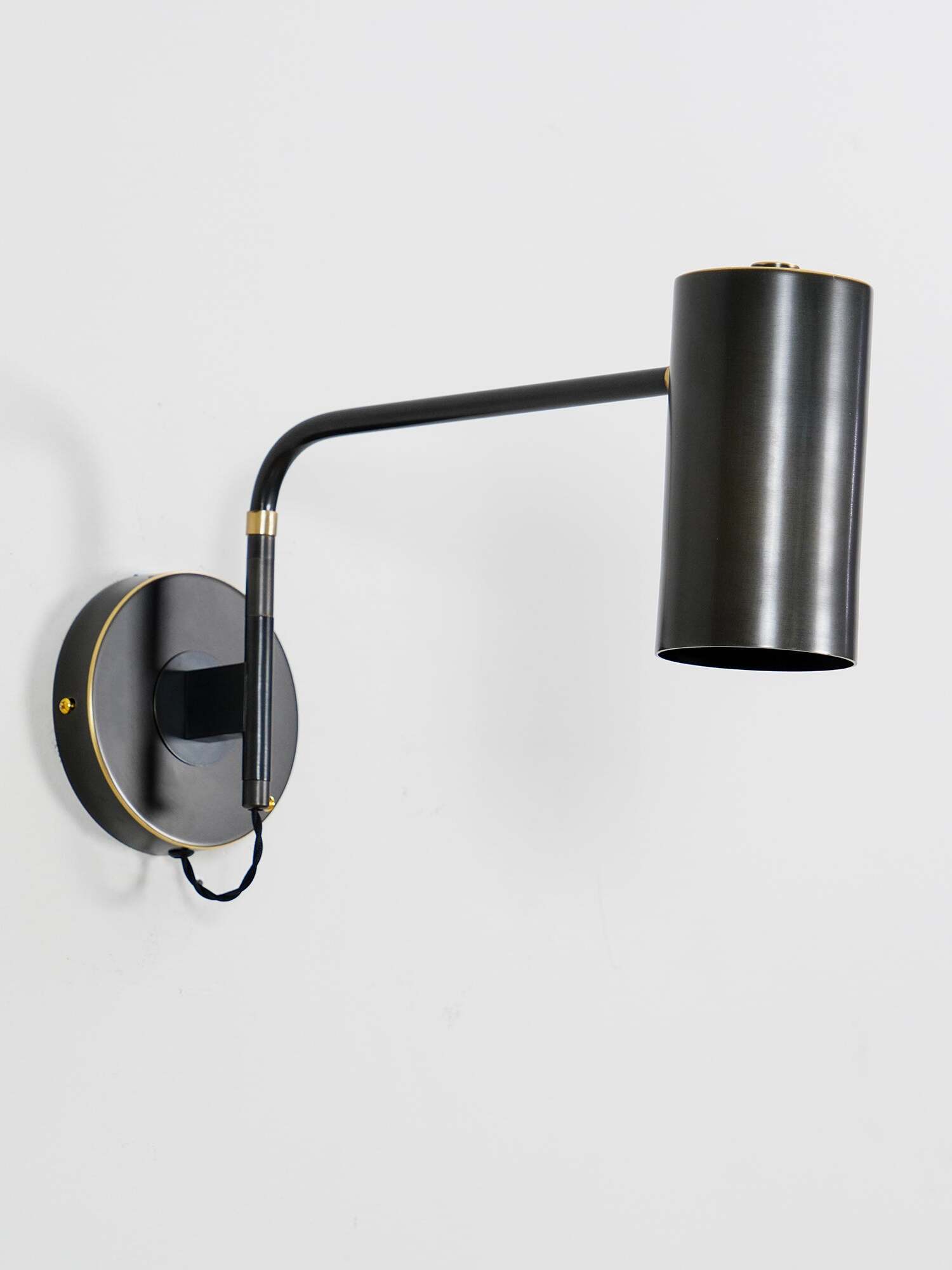 Isolated black wall light with extended arm on white background