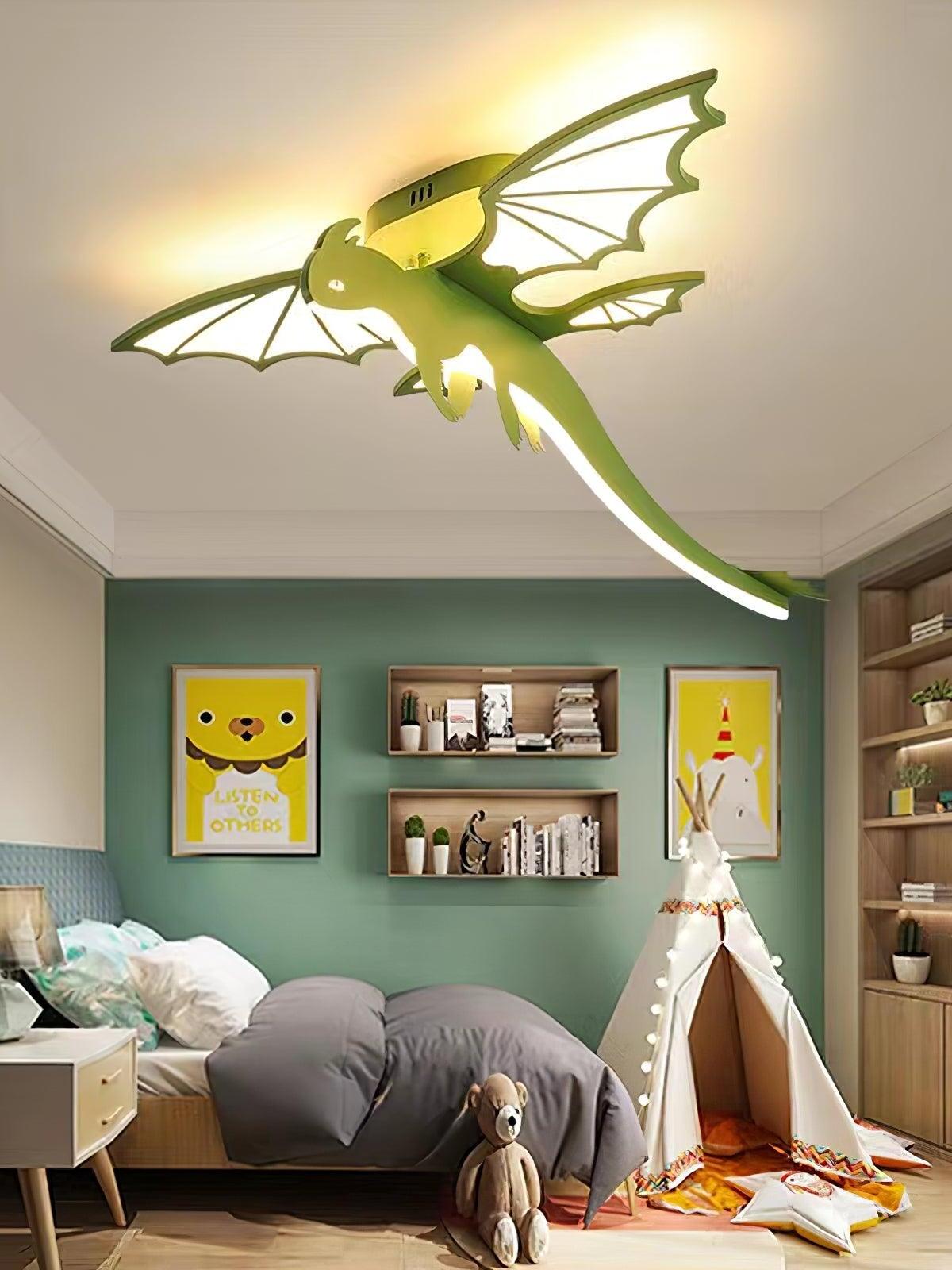 Green dinosaur ceiling light above play tent and bed