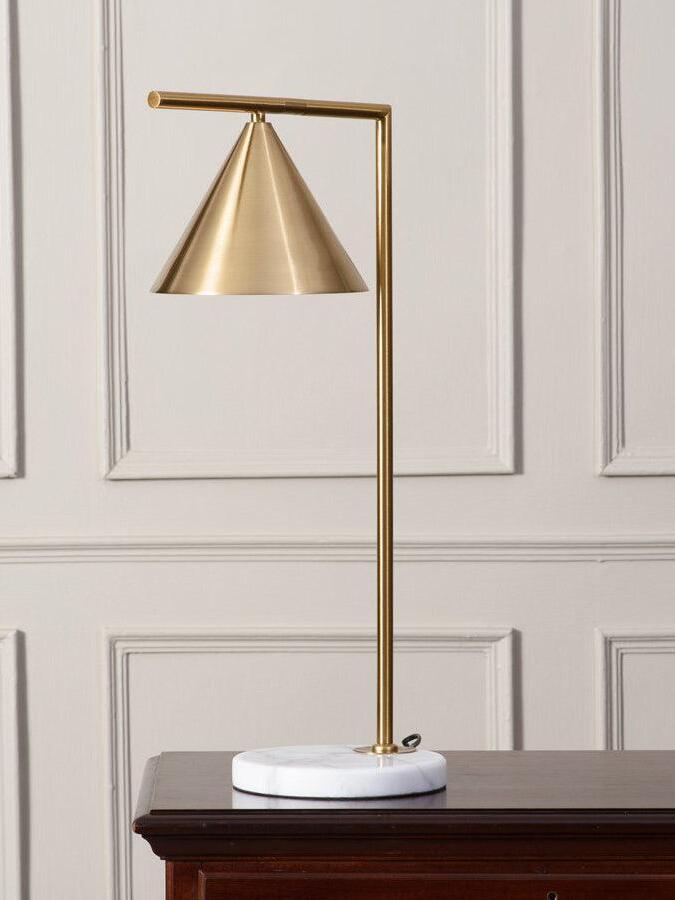 Cone table lamp on dark wood surface against panelled wall