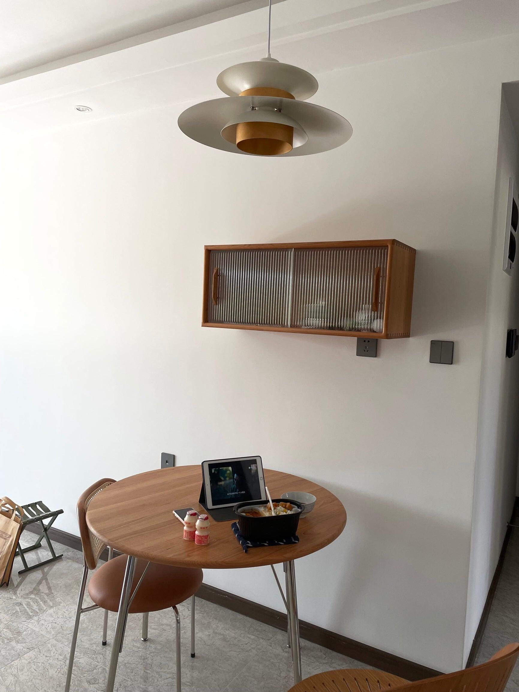 Layered pendant above a round table