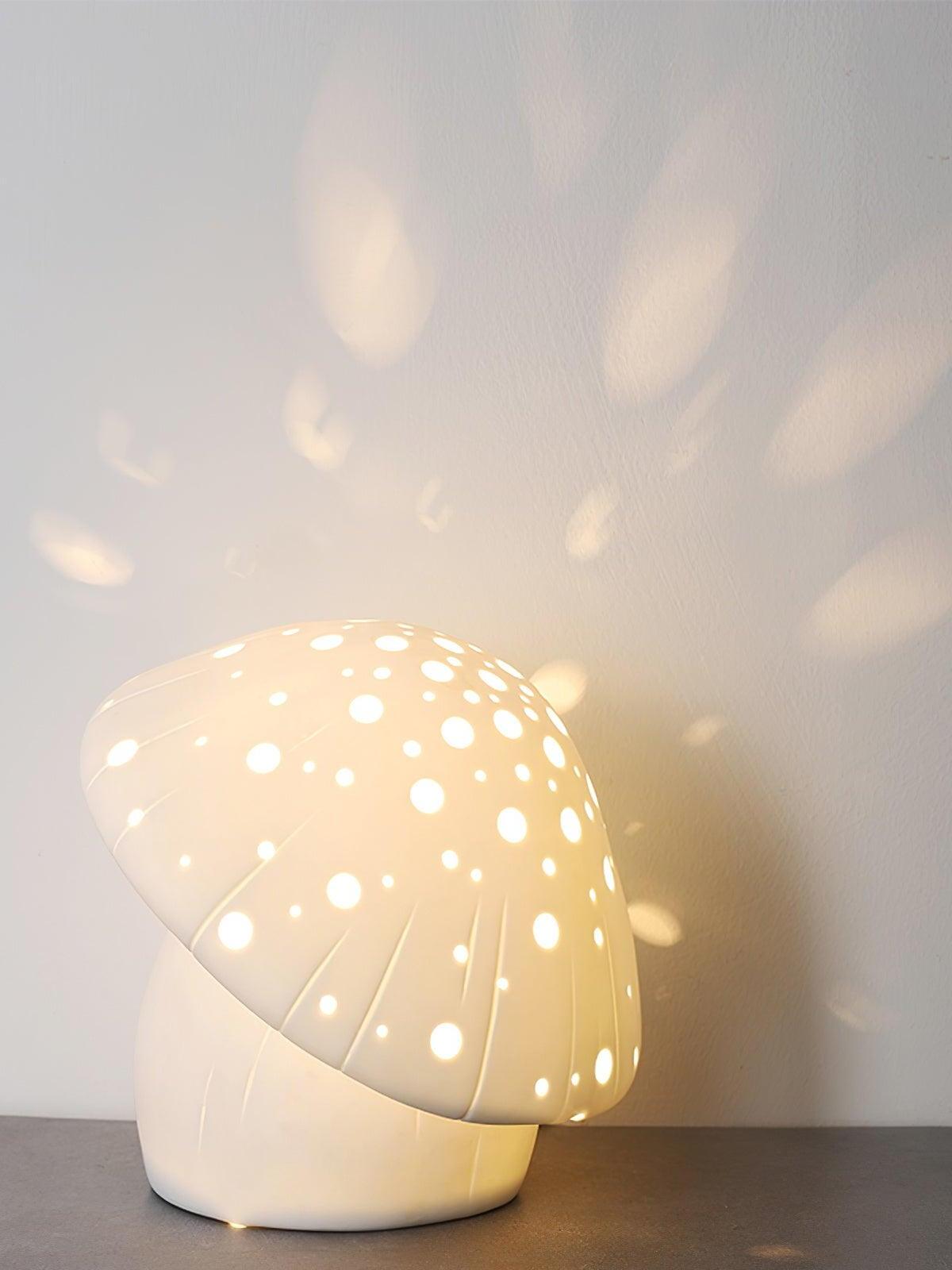 Illuminated mushroom lamp casting large and small light spots onto a pale wall