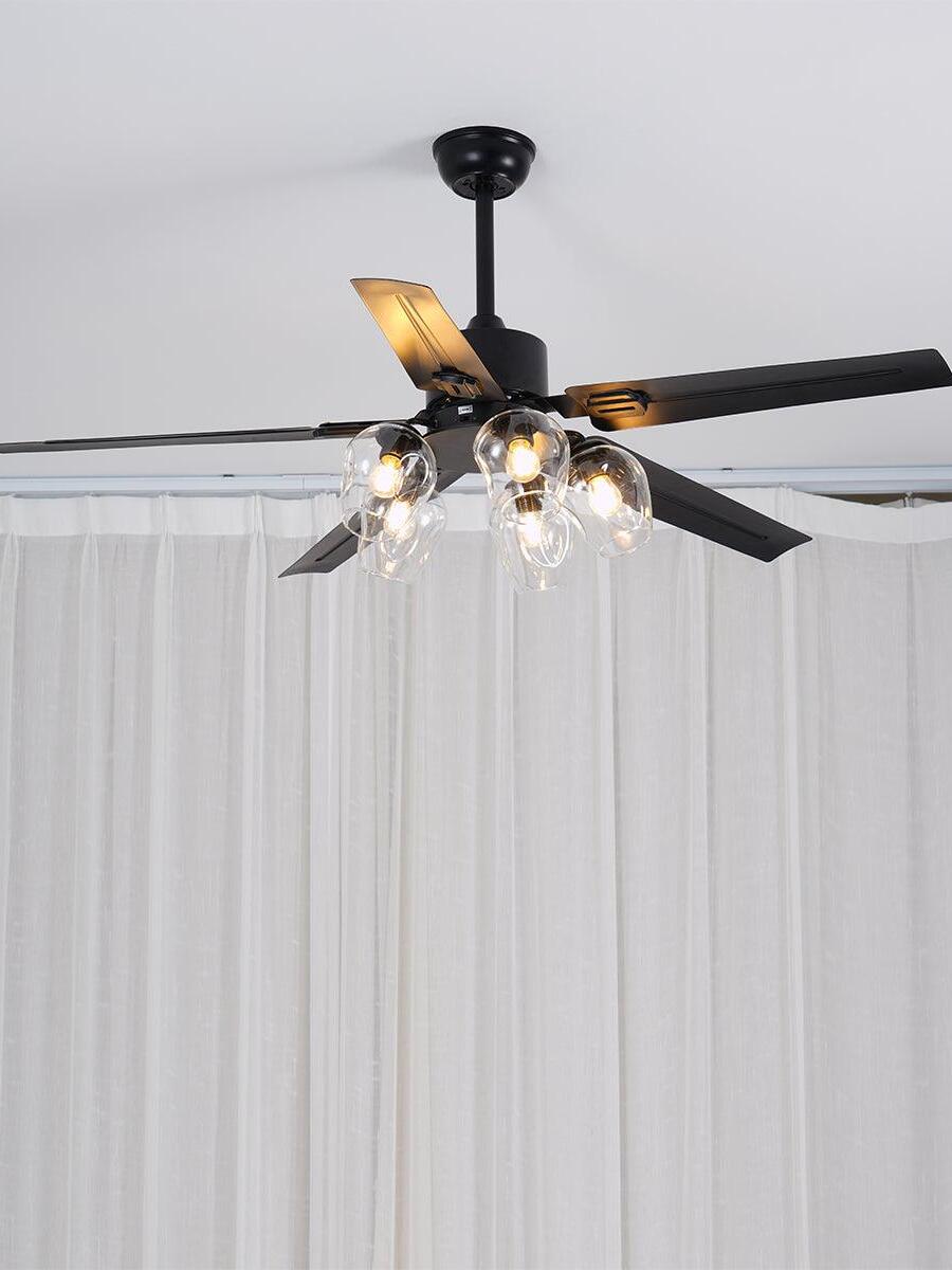 Black fan and glass lights beneath a pale ceiling