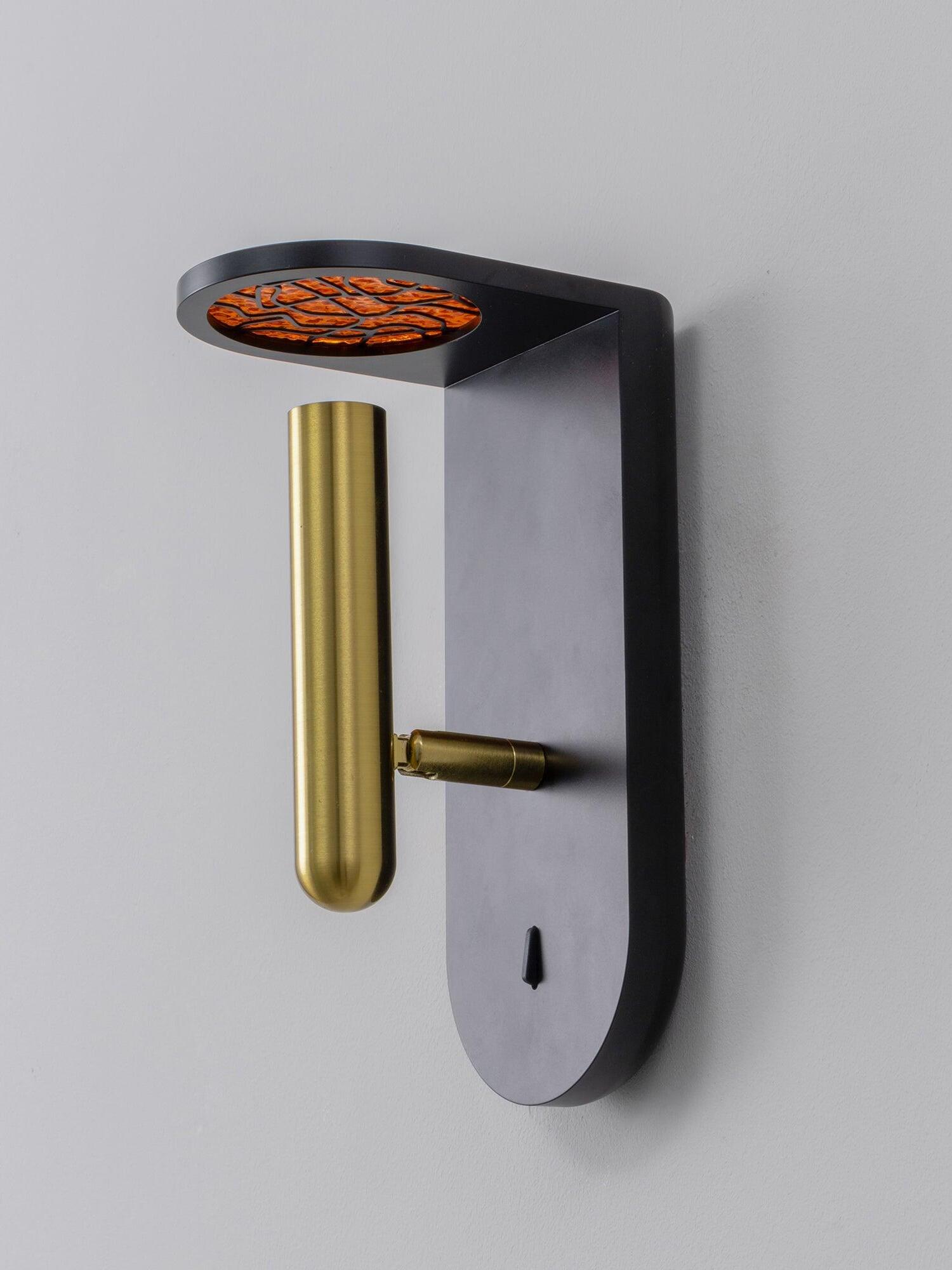 Black Nights wall light viewed from below, showing the textured upper light and cylindrical head