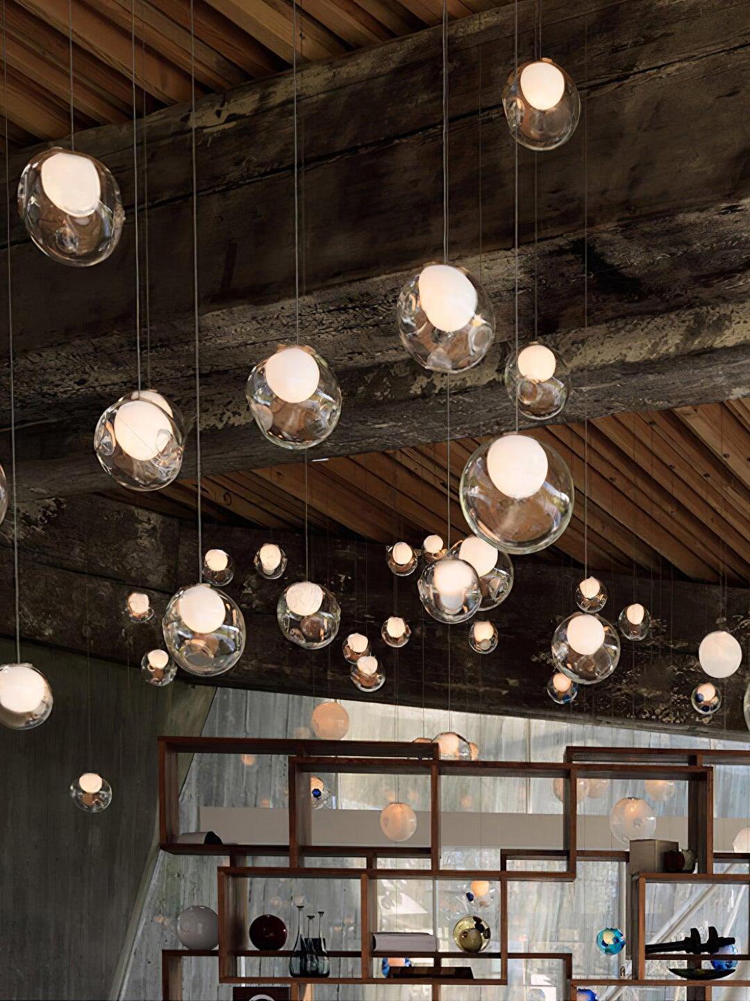Lit clear globes hanging under timber ceiling
