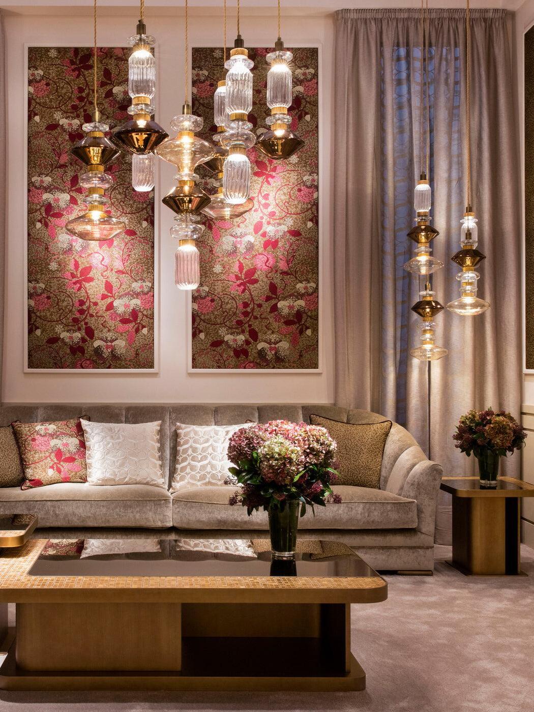 Ballet glass pendants at different heights over a sofa