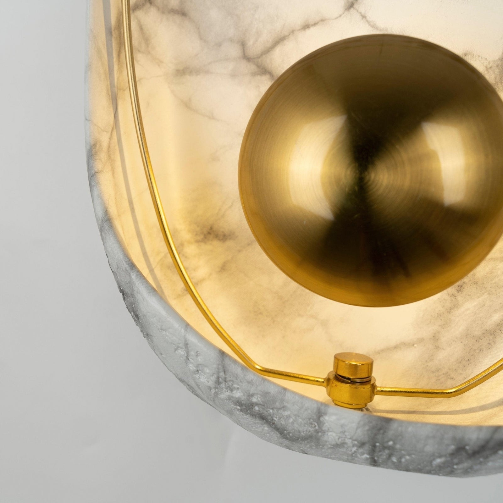Gold-coloured central cap and fine loop against the lit face