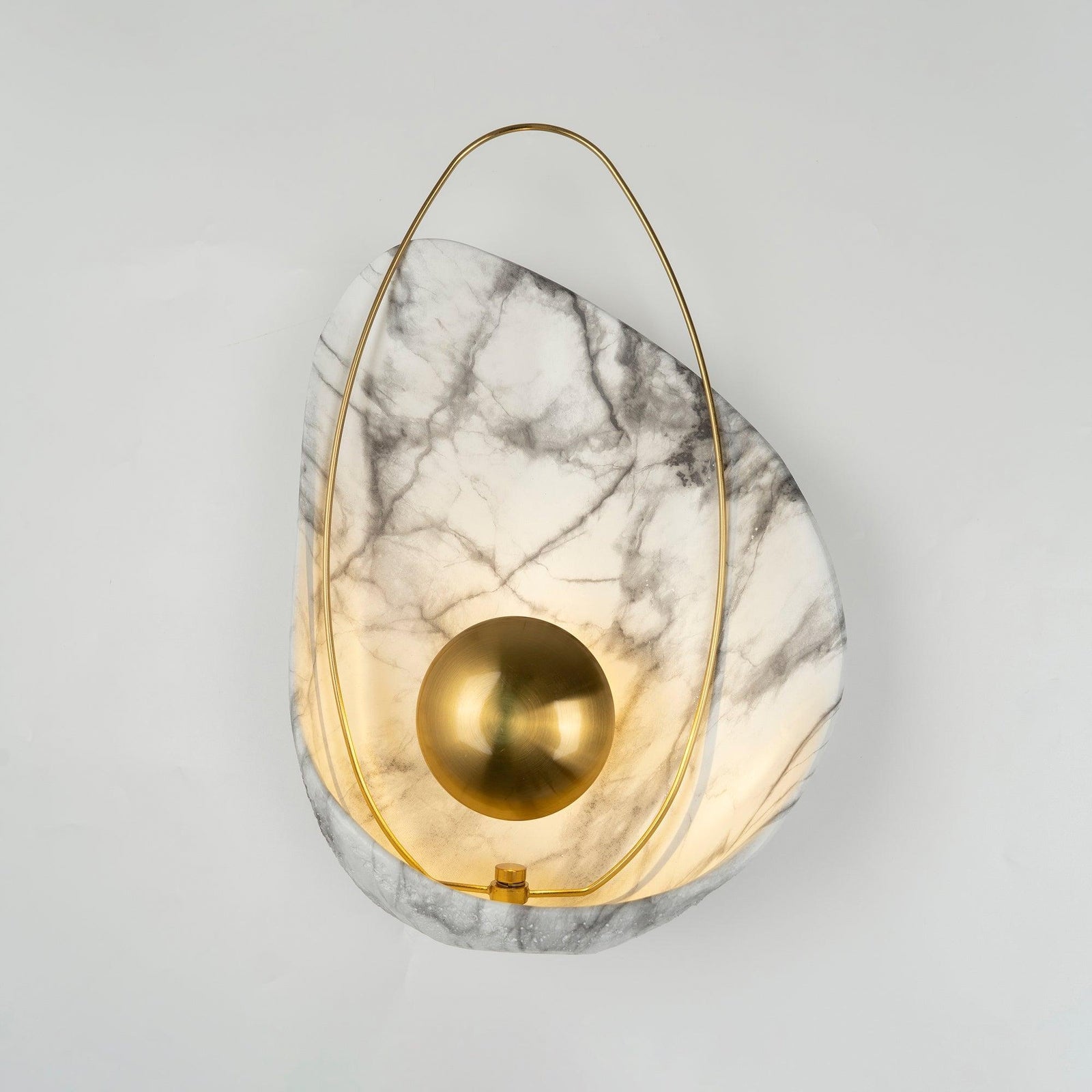 Front view of the illuminated shell-shaped wall light