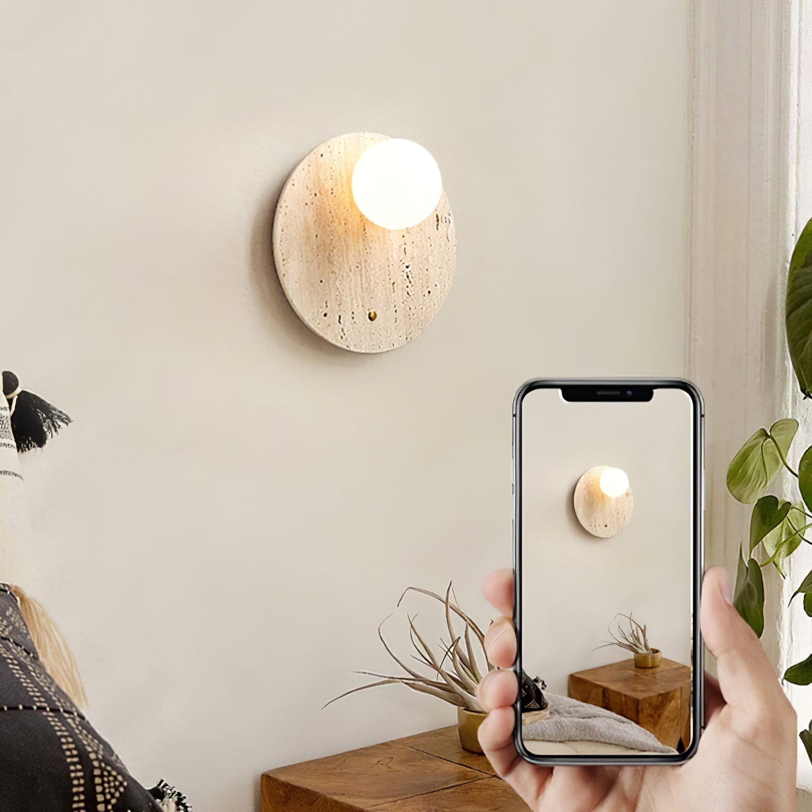 Travertine globe wall light beside a phone displaying the fixture