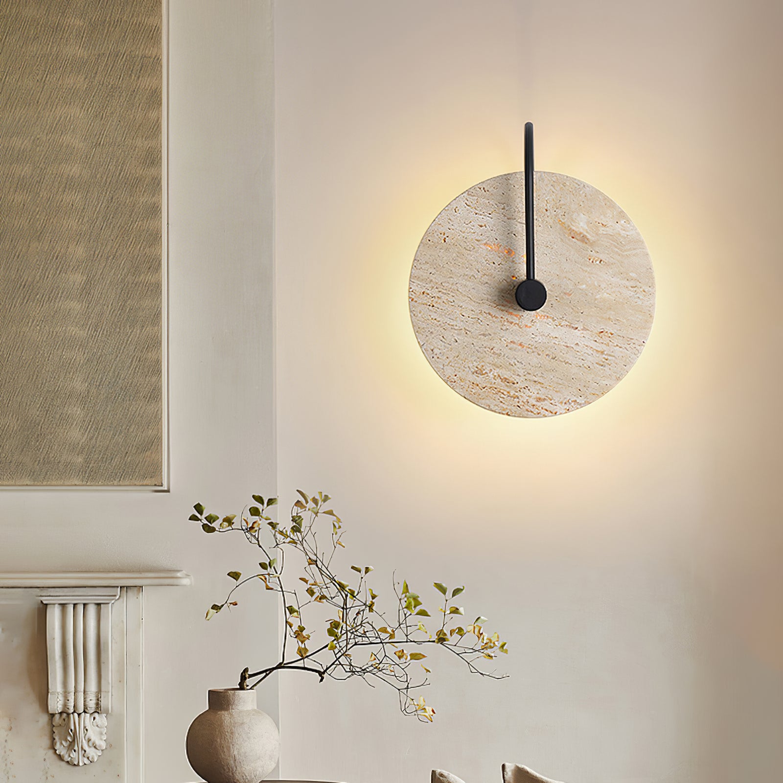 Illuminated travertine disc beside a dining area