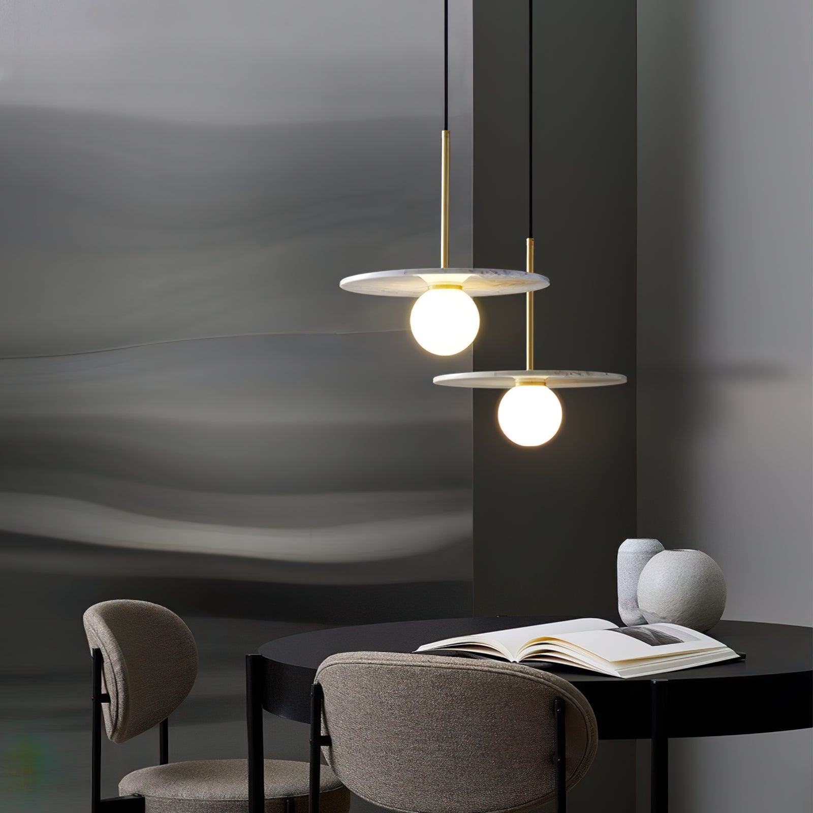 Pair of white marble pendants above a dining table and chairs