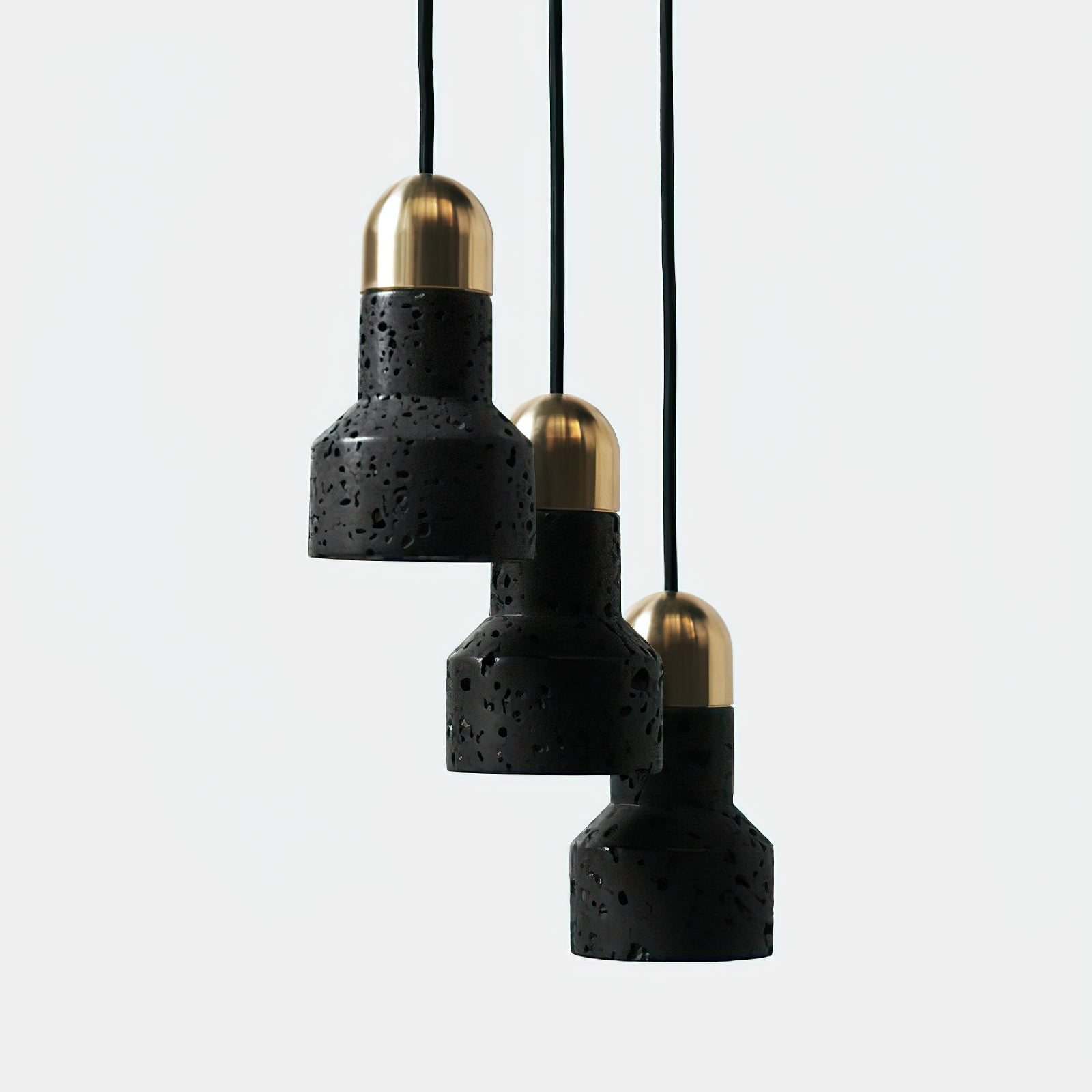 Three gold-capped black pendants in a descending arrangement