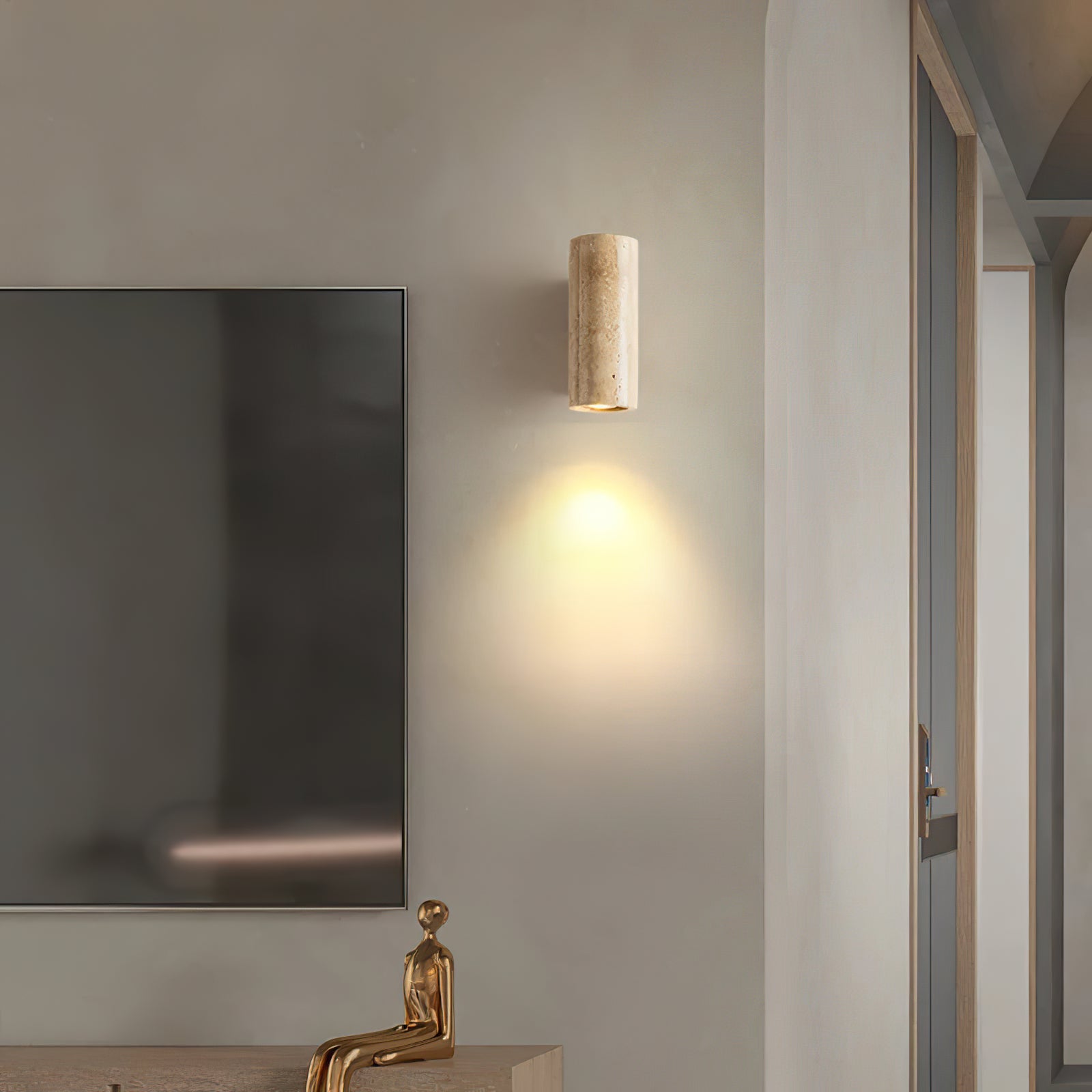 Cylindrical stone wall light beside a television