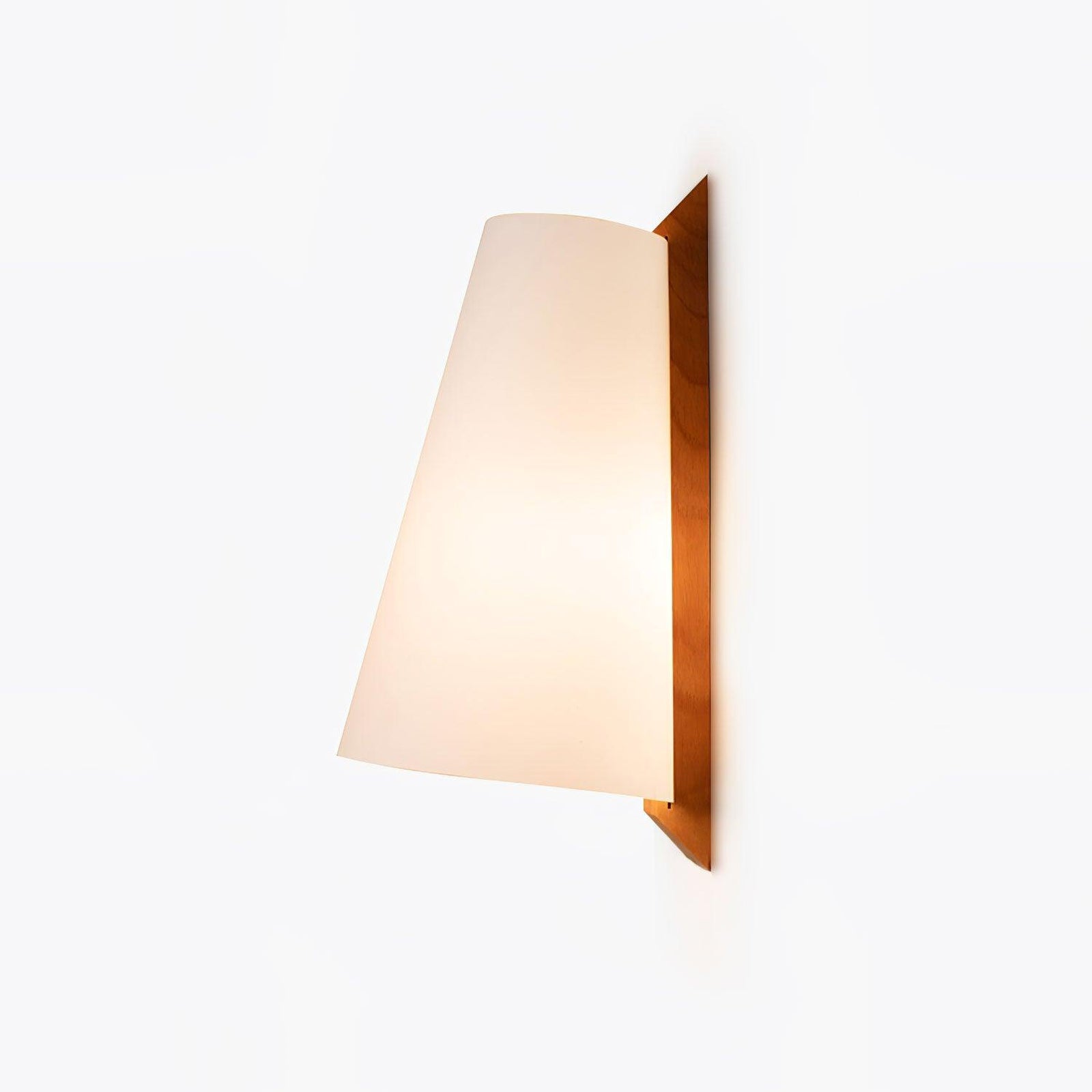 Angled Lupe wall lamp with light glowing through the shade