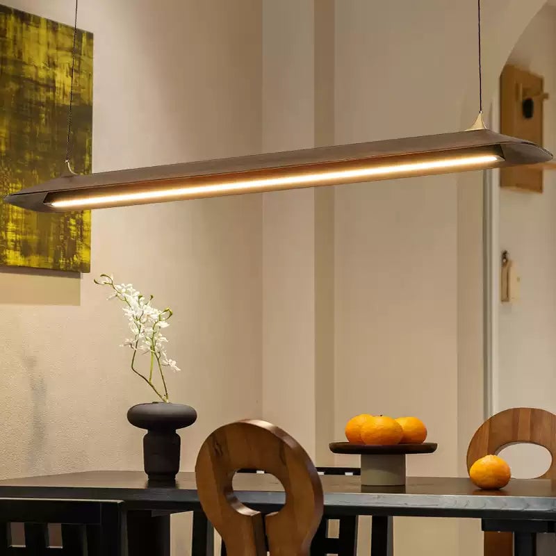 Illuminated Mernoe pendant above a dark dining table