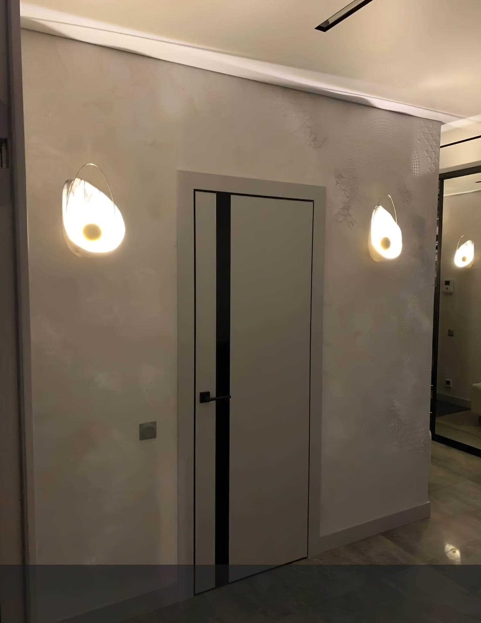 Shell-shaped lights along an indoor corridor