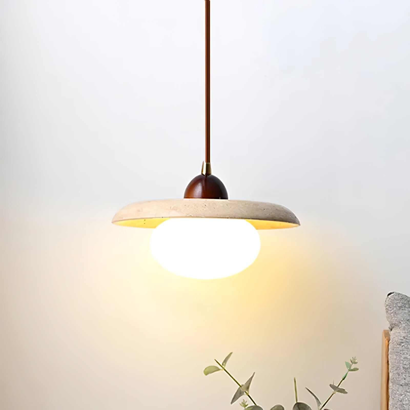 Close view of illuminated rounded diffuser beneath the stone disc