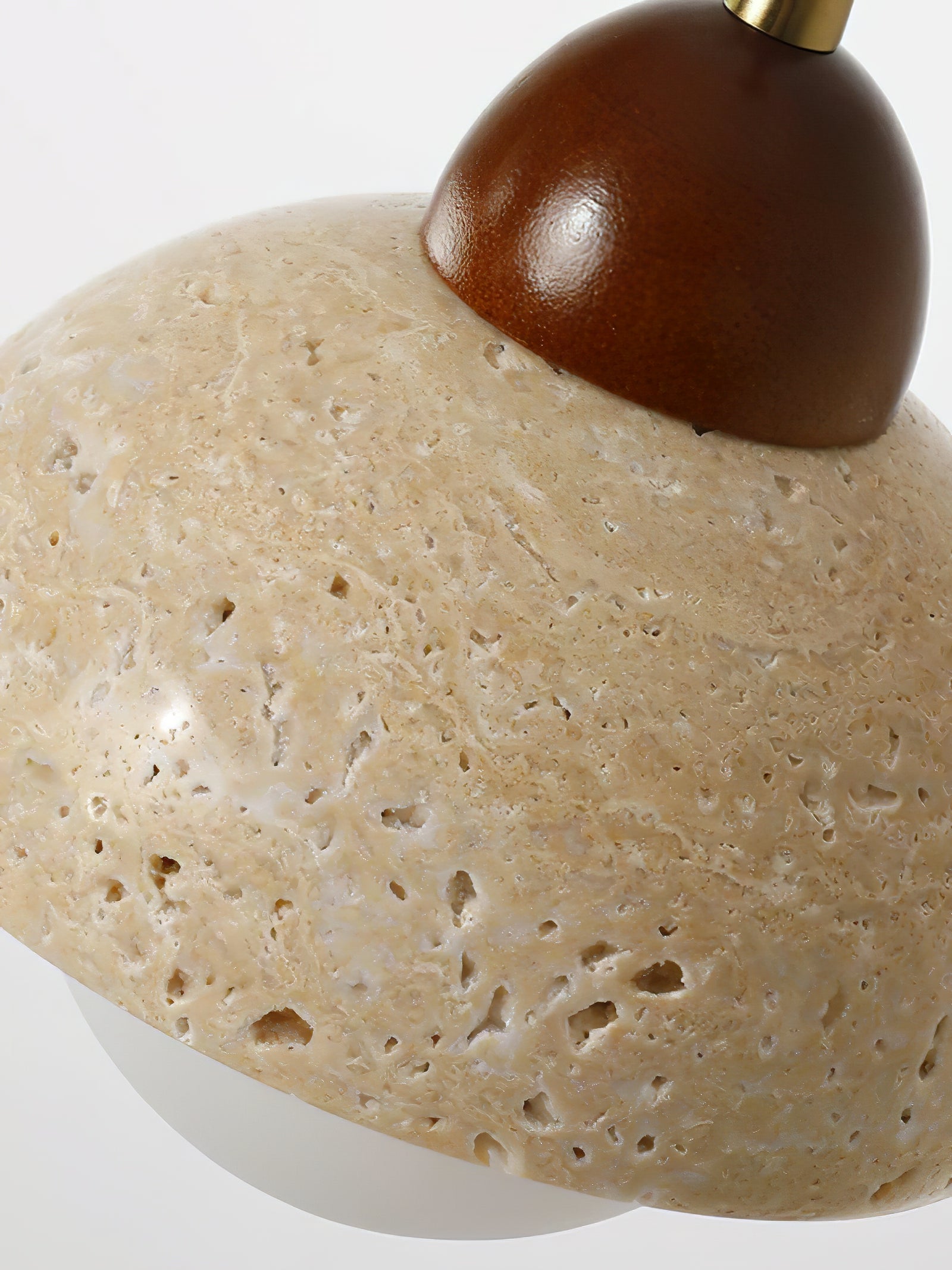Angled close-up of porous stone and rounded wood top