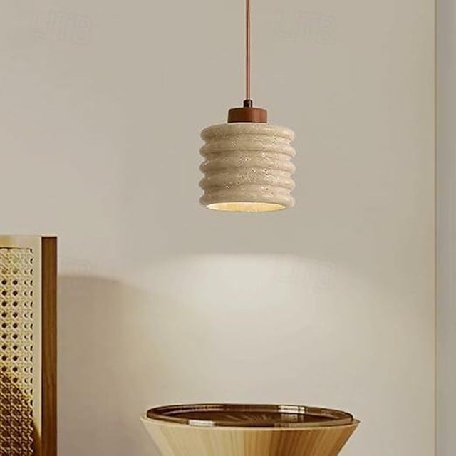 Close view of horizontal ribs on a hanging stone cylinder