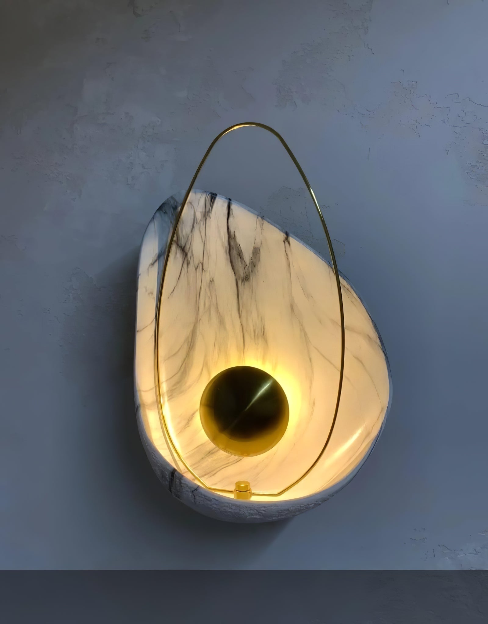Angled shell wall light showing its curved face and loop