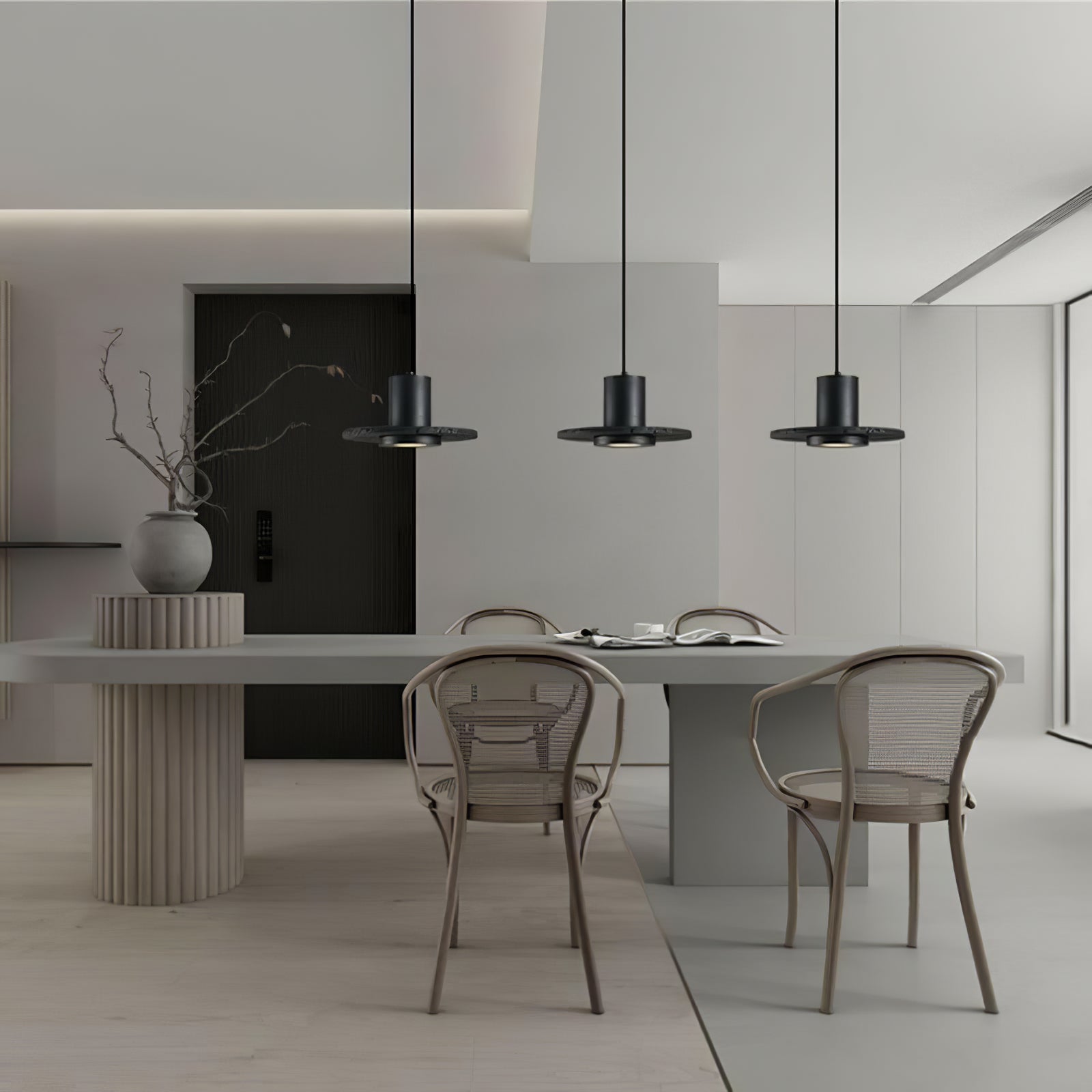 Three black disc pendants above a long dining table