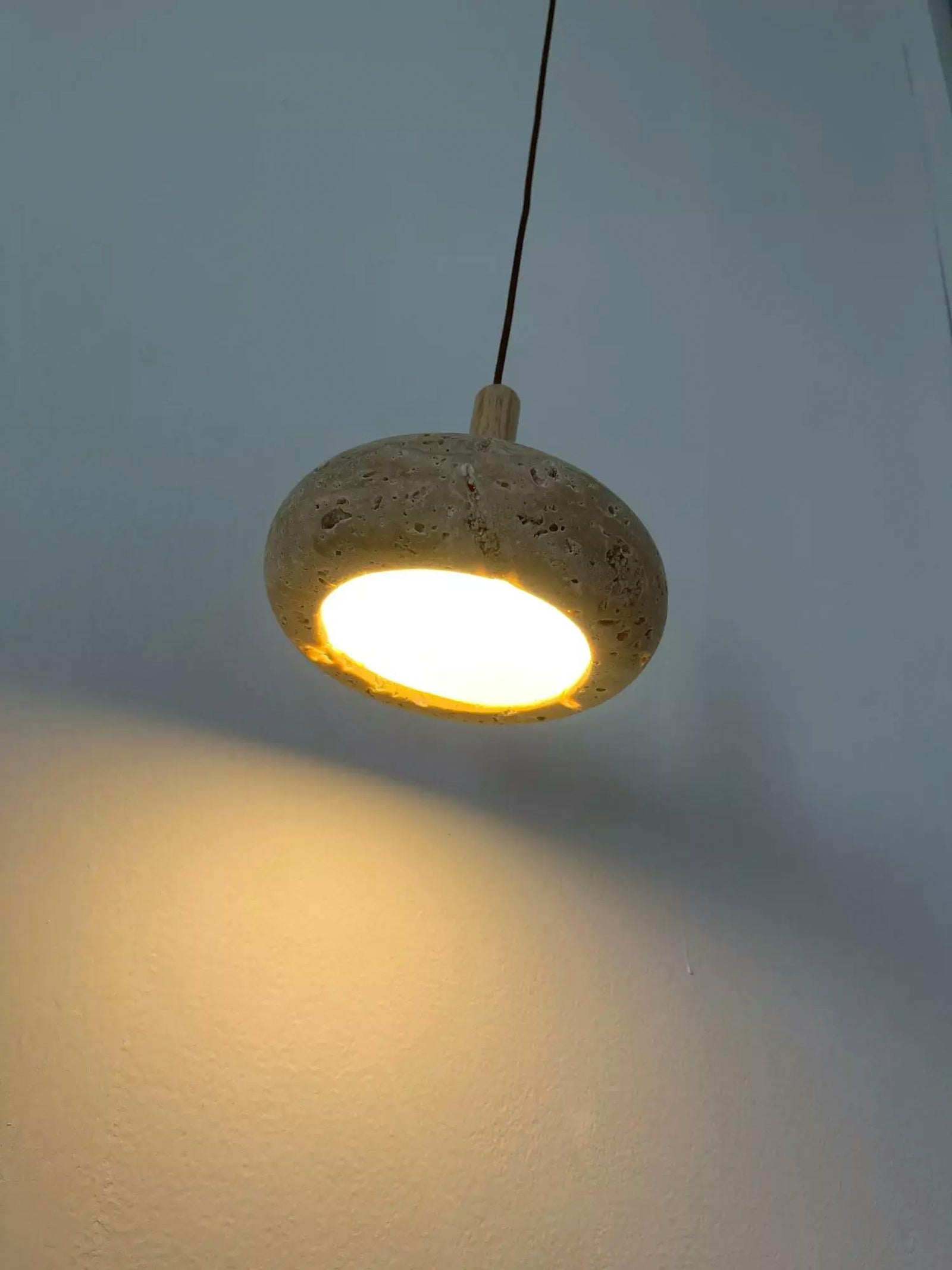 Angled underside of illuminated rounded stone shade