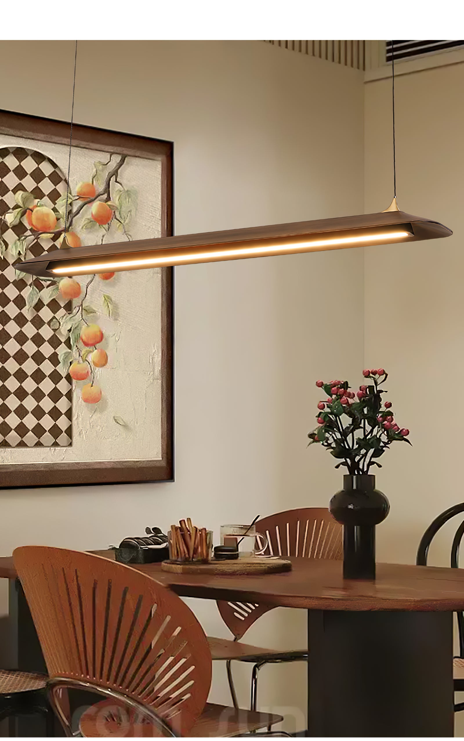 Wood-finish pendant over a table beneath framed artwork