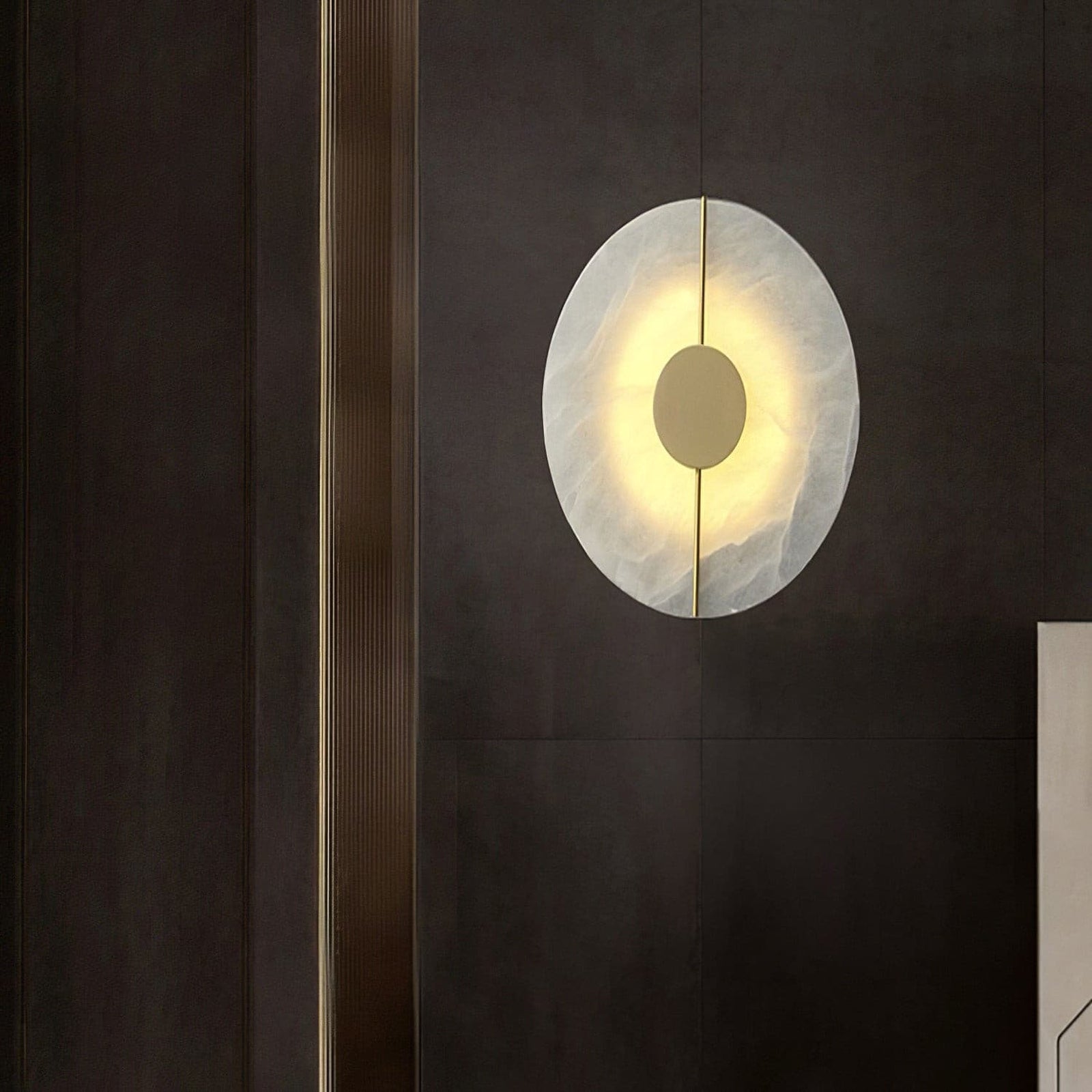 Angled marble wall light on a dark wall