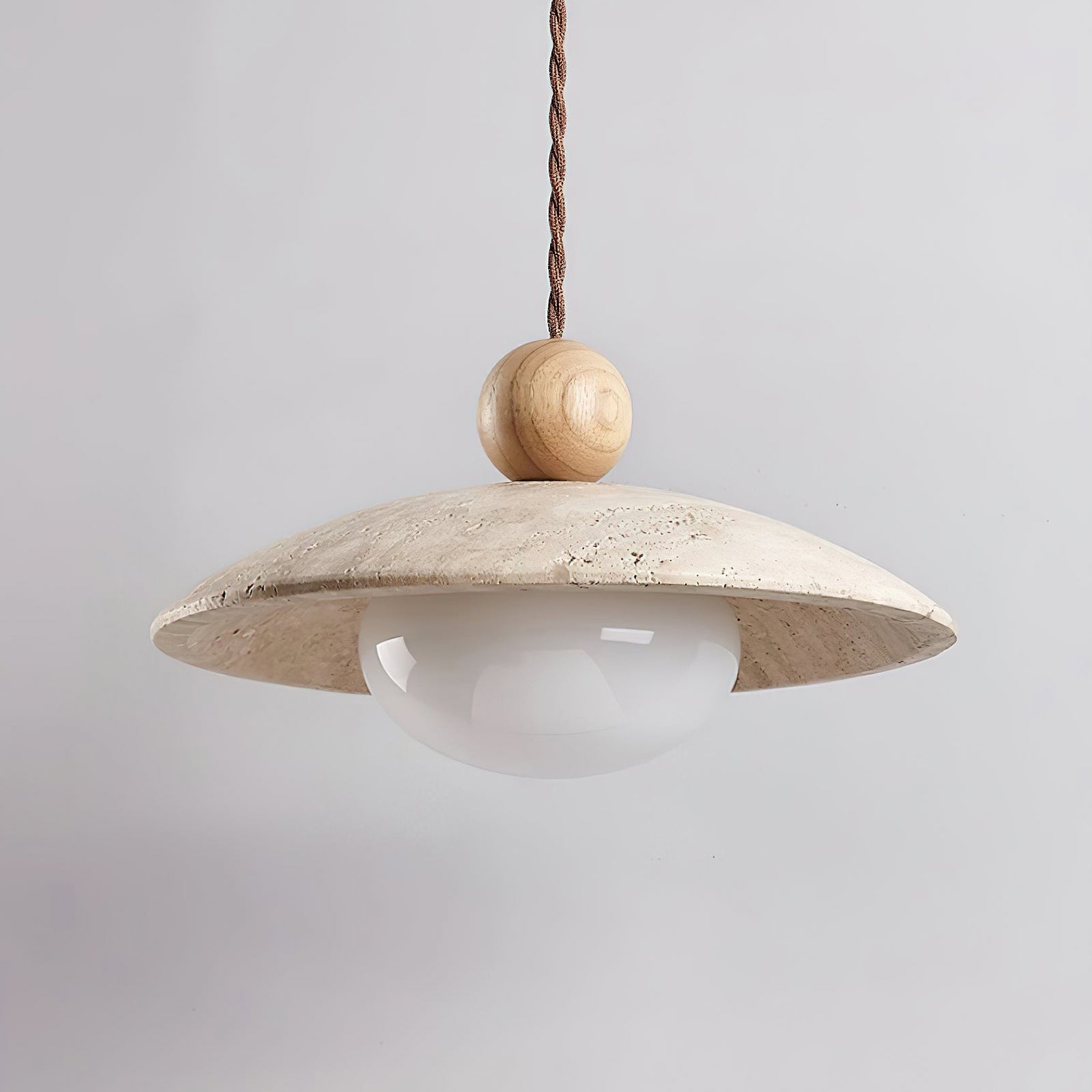 Unlit white lower globe beneath a stone disc and light wood sphere