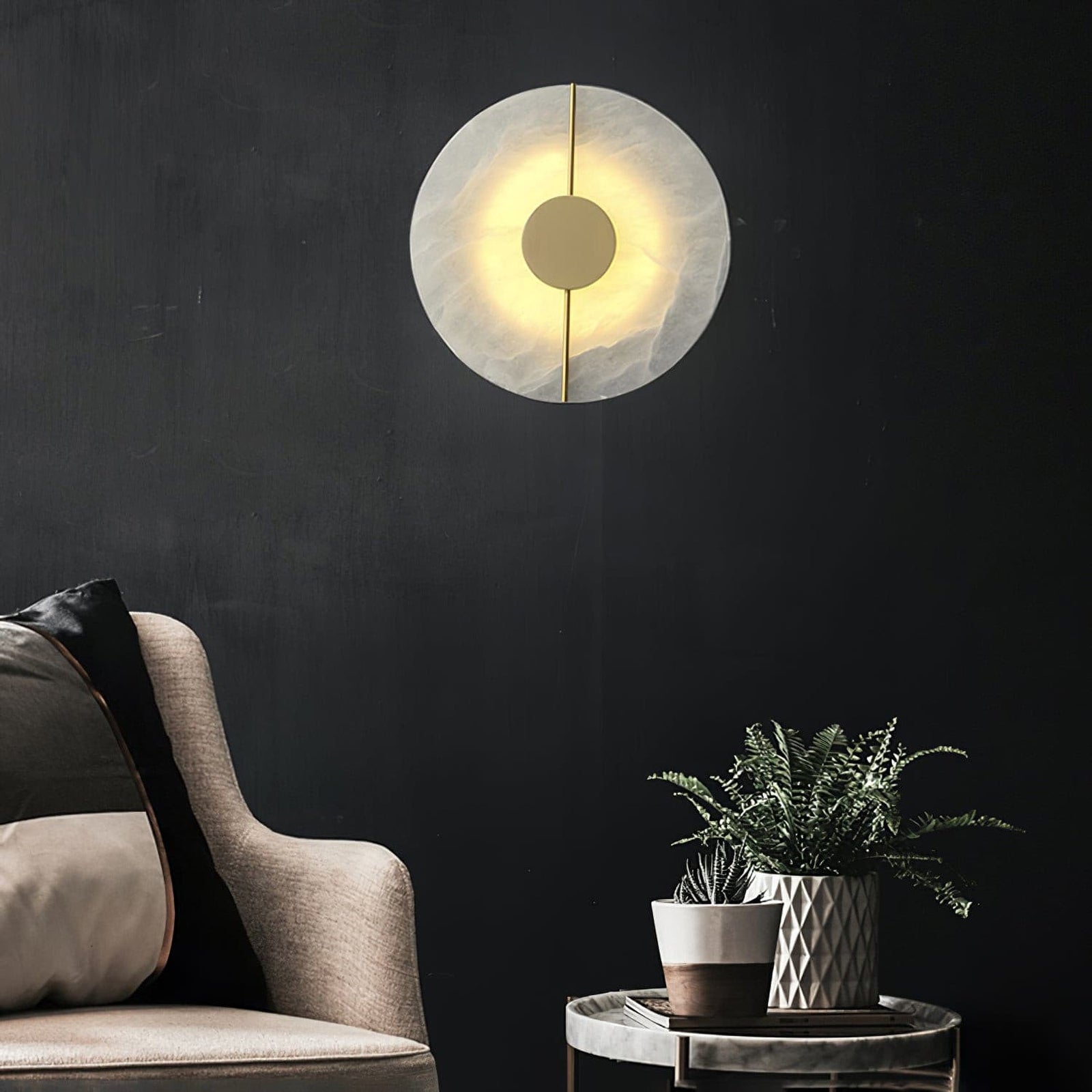 Illuminated marble wall lamp above seating on a dark wall