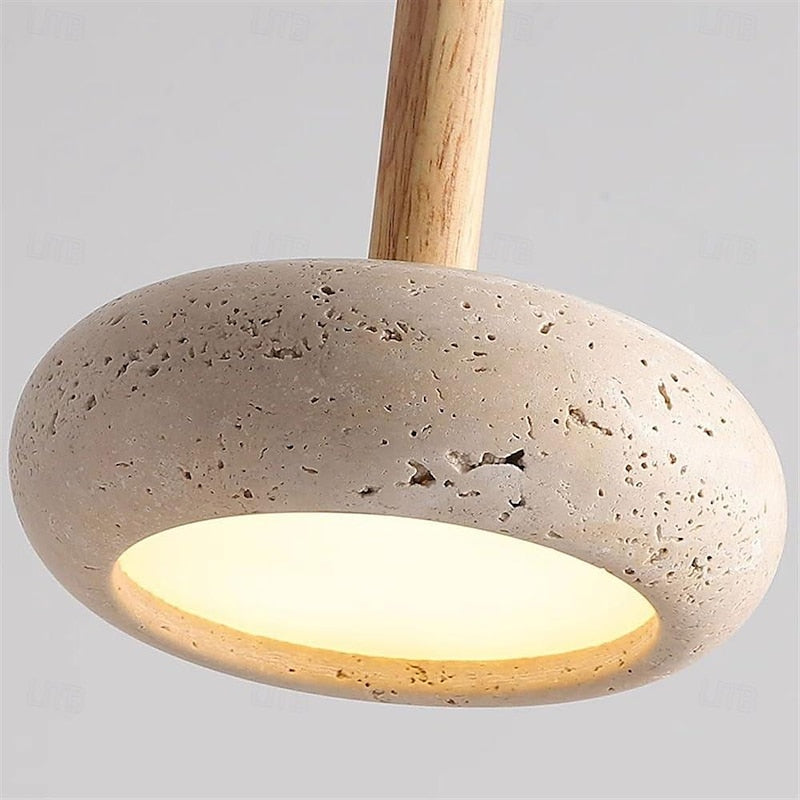 Close-up of lit recessed circular surface and porous stone rim