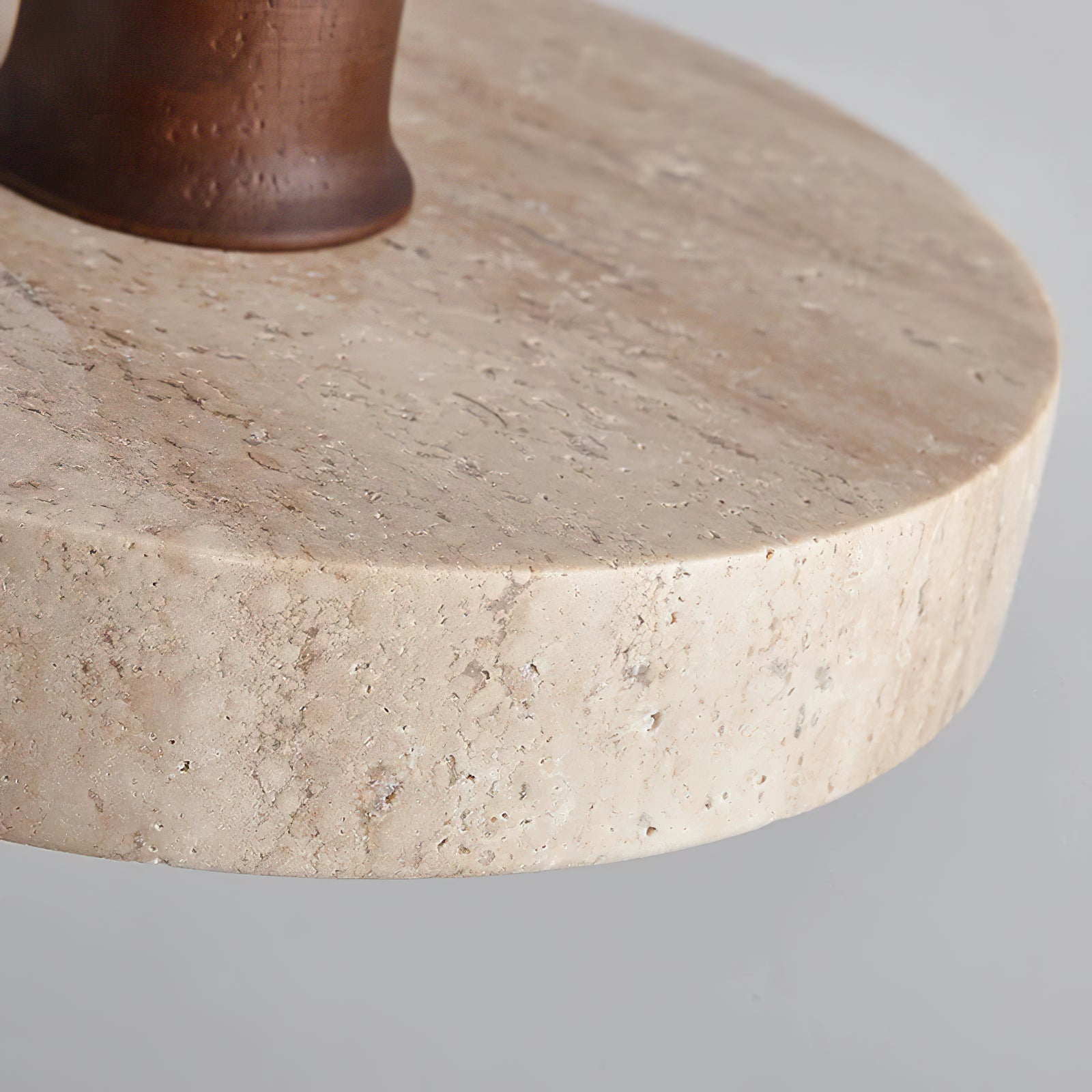 Detail of textured stone around the dark wooden stem