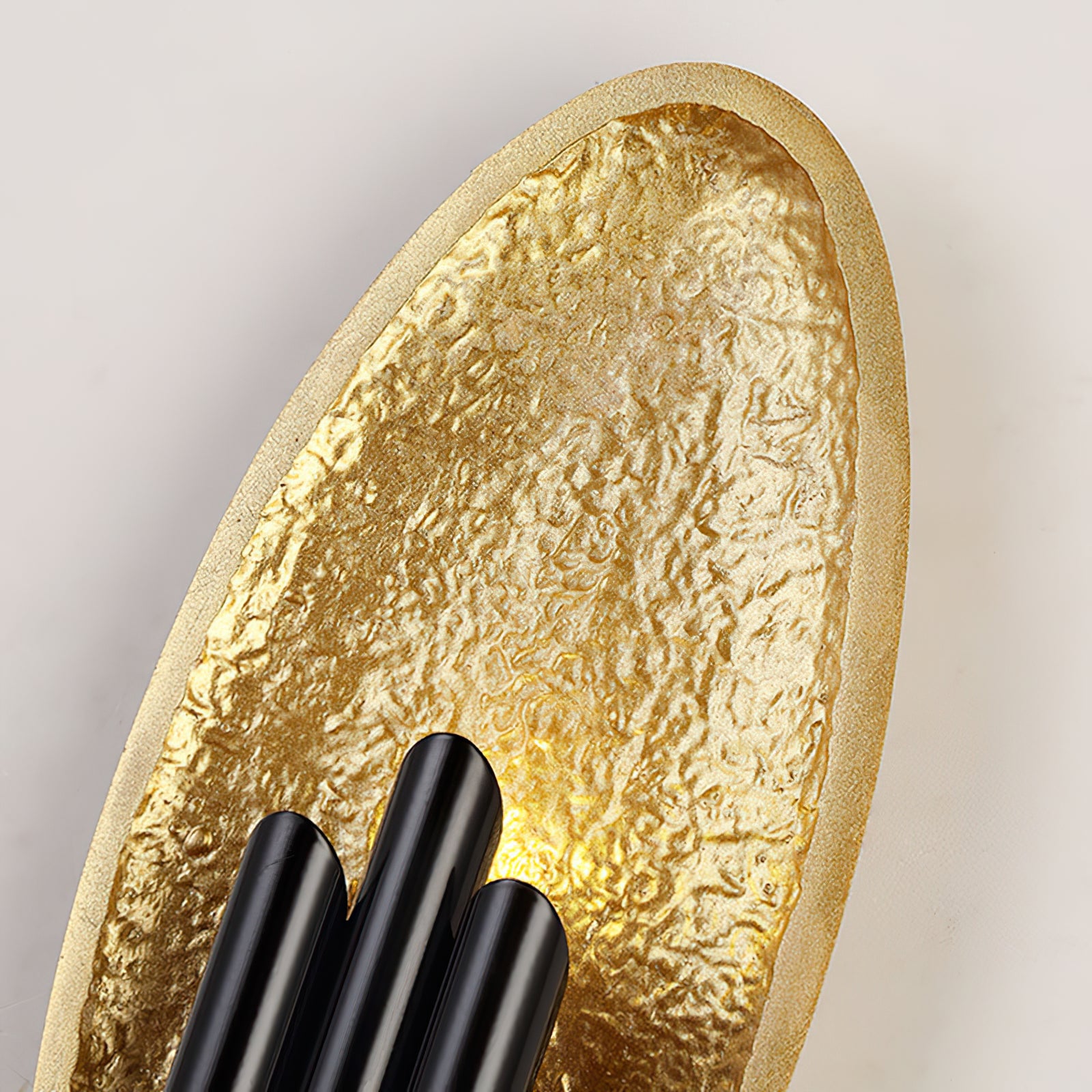 Detail of the gold textured oval and staggered black bars
