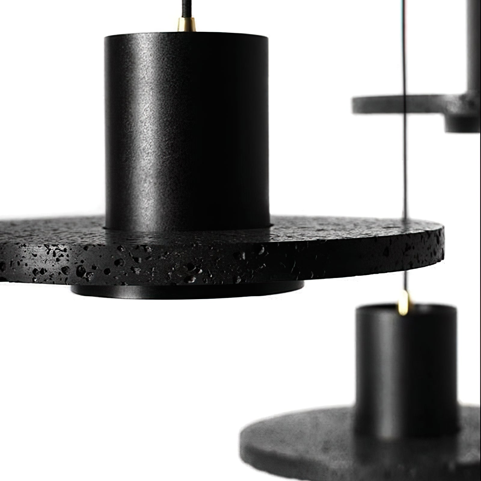 Close-up of porous black stone around a smooth cylinder