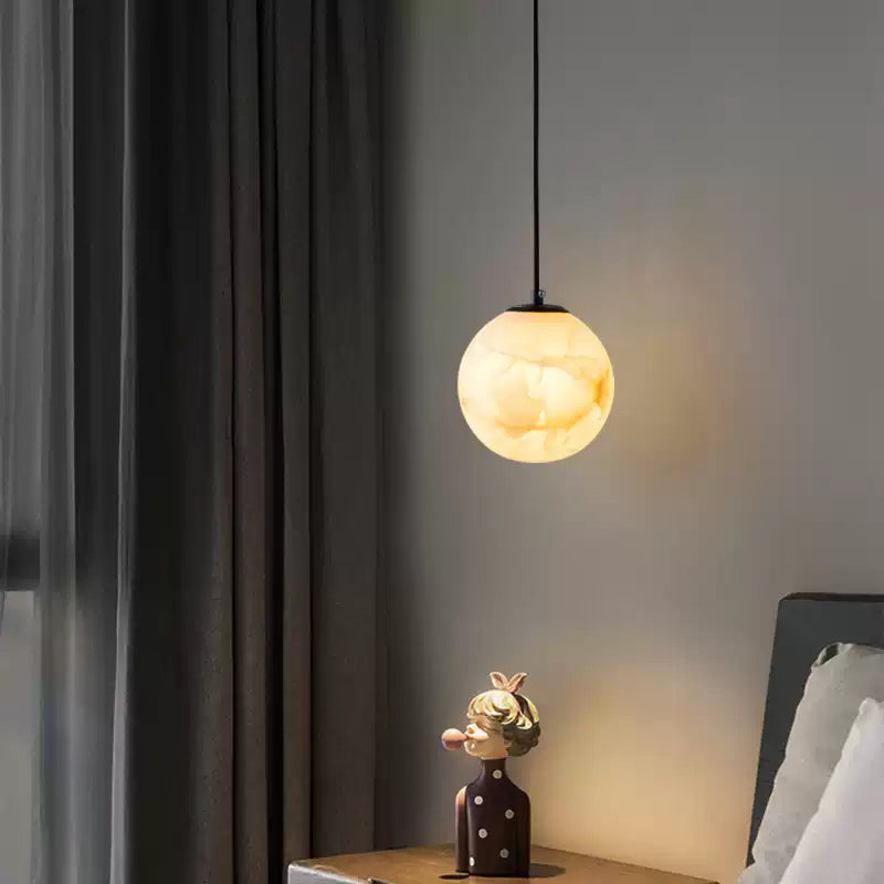 Illuminated globe beside curtains and a chair