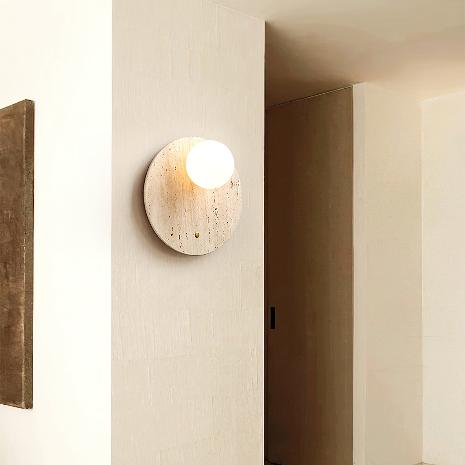 Illuminated stone and glass wall light beside a doorway