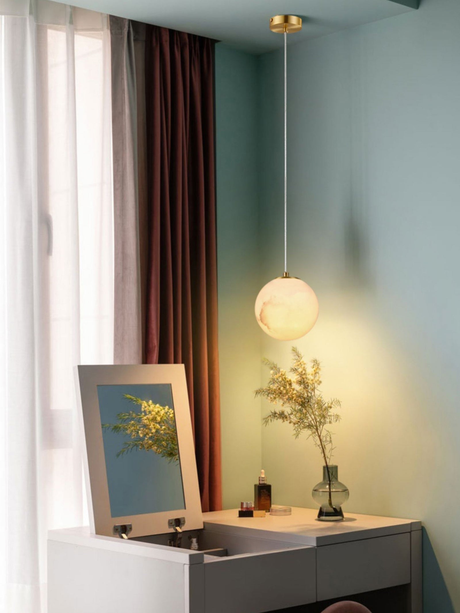 Small globe pendant above a bedroom dresser