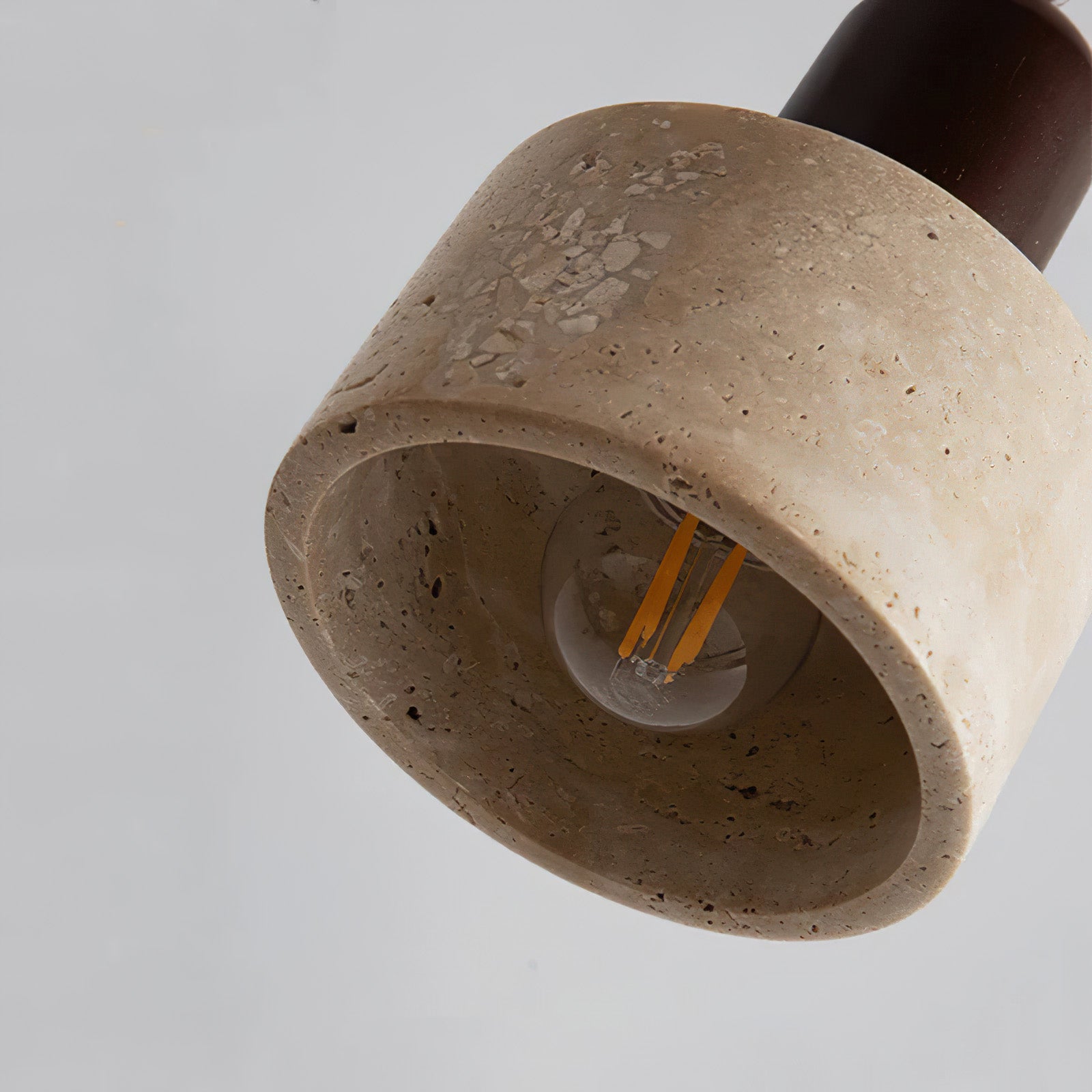 Underside close-up showing a clear bulb inside the stone cylinder