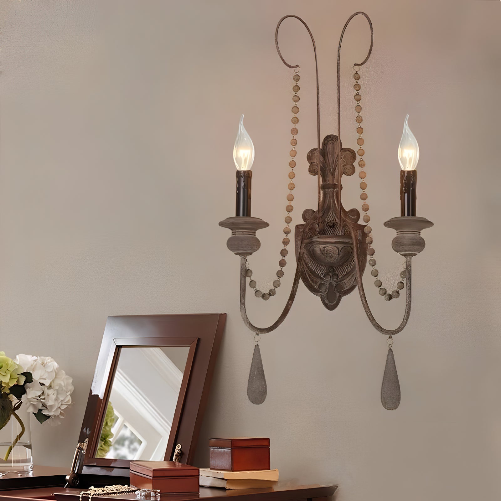 Double-arm wood wall sconce above a console table