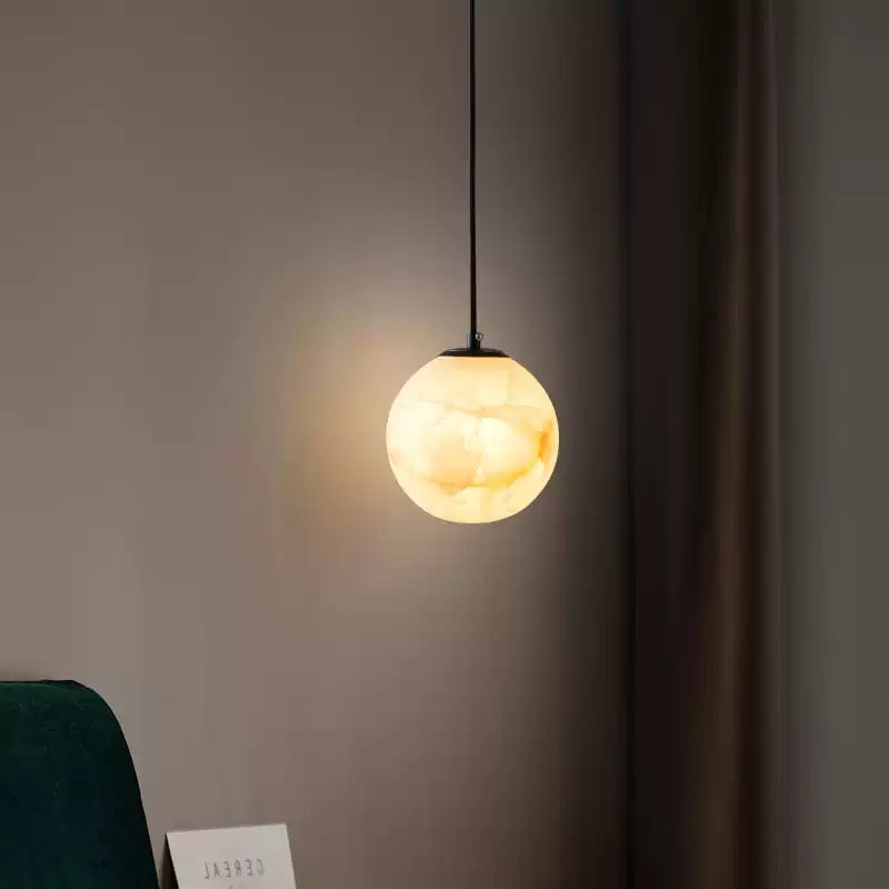 Small lit stone globe with dark cable and top fitting