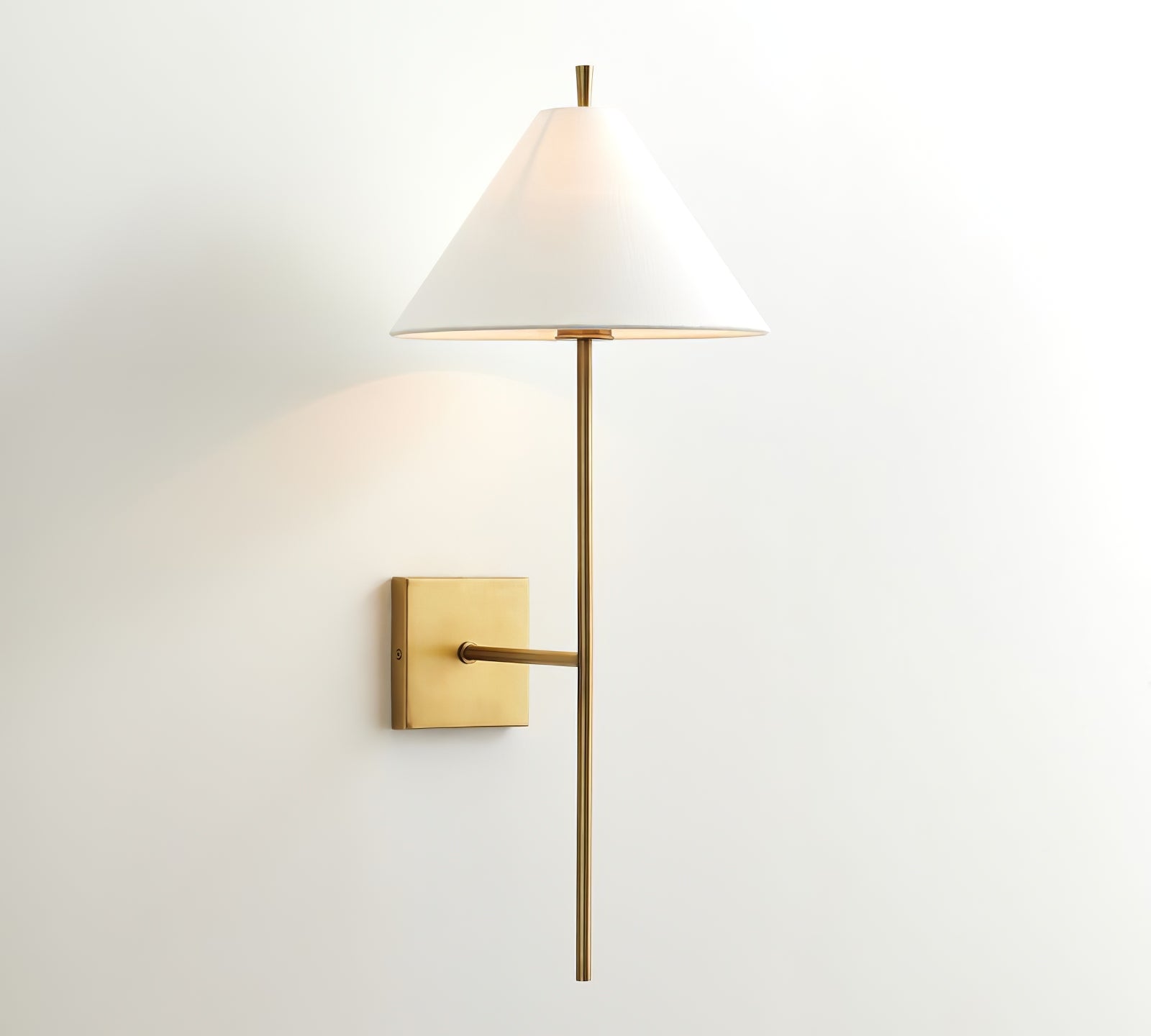 Illuminated gold Ellis wall light viewed from the front