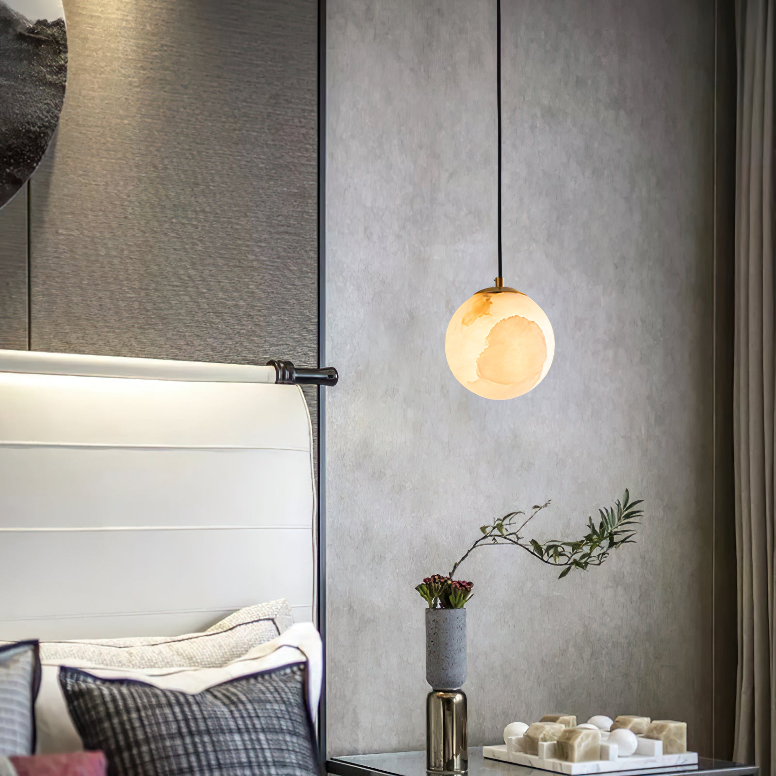 Illuminated stone globe beside a tall upholstered headboard