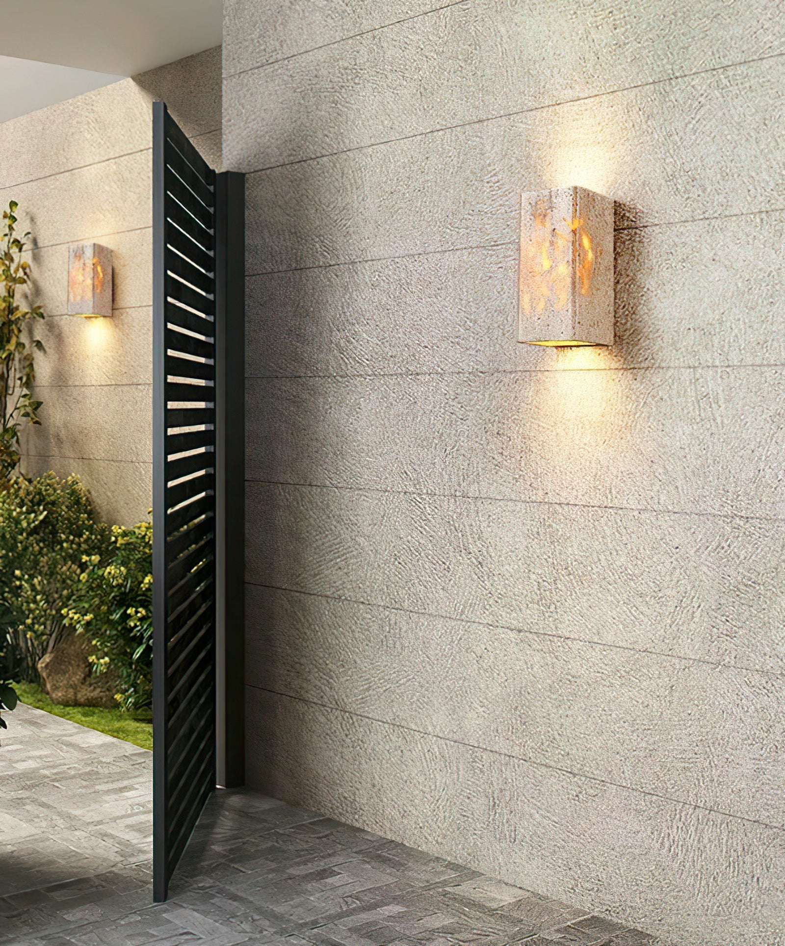 Pair of glowing stone sconces beside an open dark door
