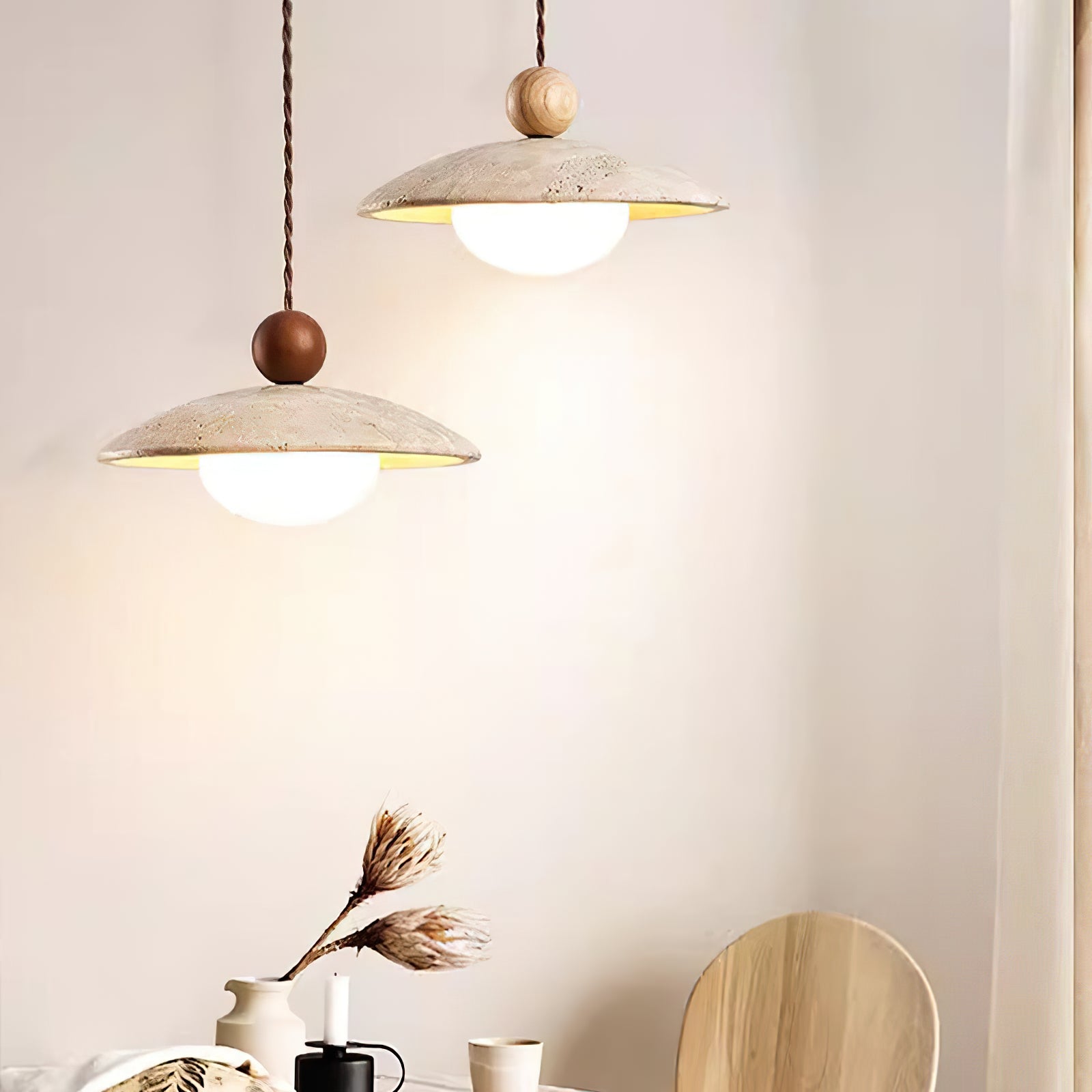 Dark and light wood-sphere pendants above a dining table