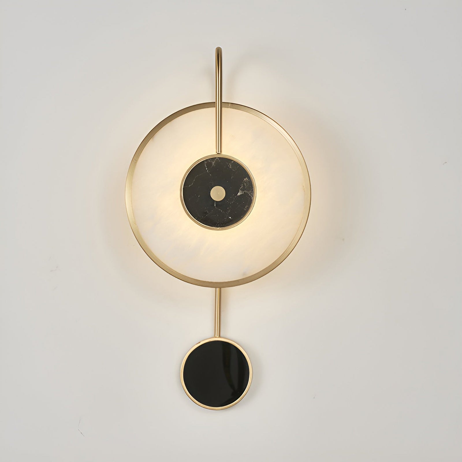 Lit circular stone wall light with small black accent below