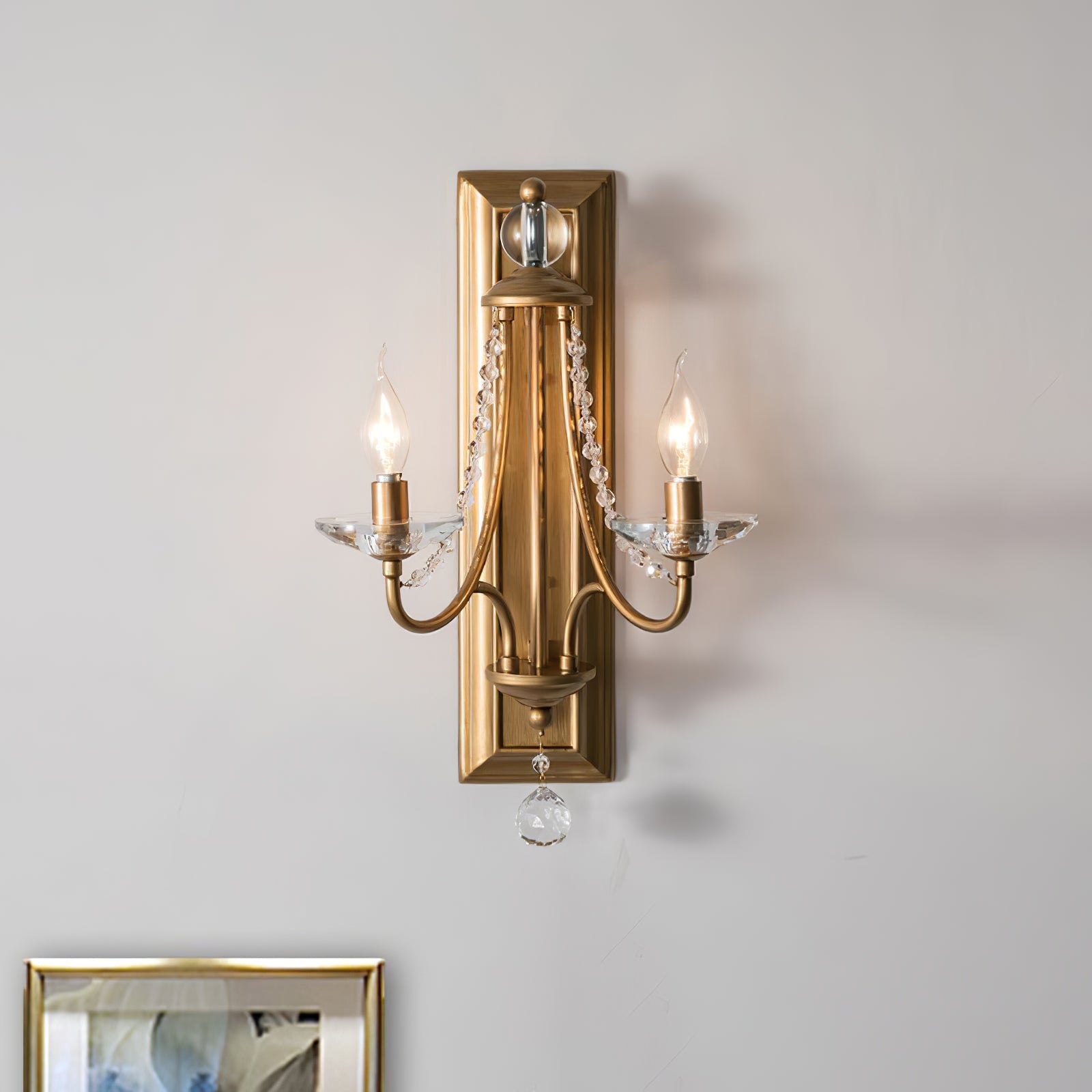 Copper-finish sconce with crystal strands on a pale wall