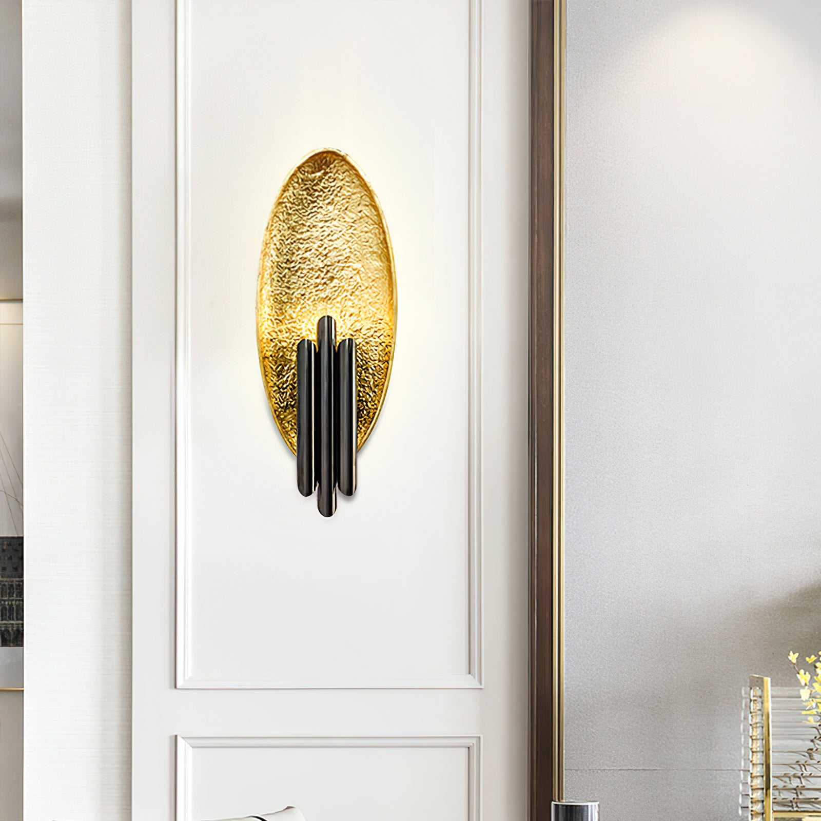 Black-and-gold oval wall light on white wall panels