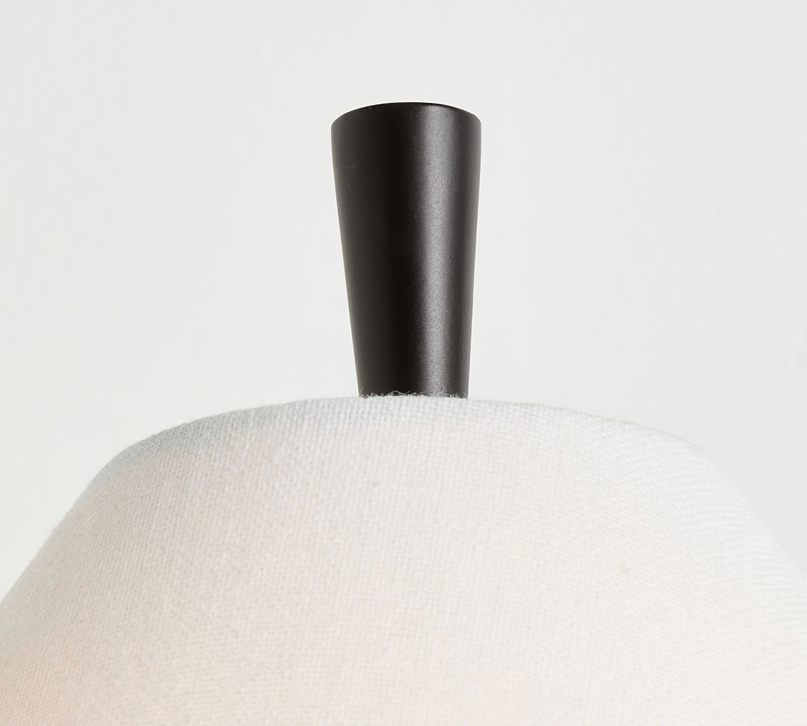 Black Ellis finial above a textured white linen shade