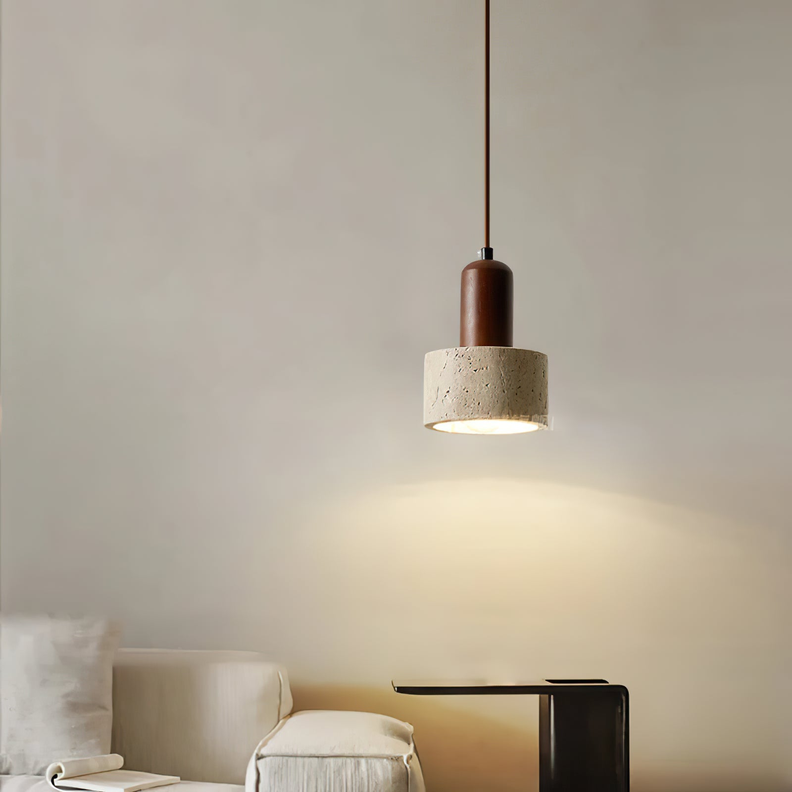 Small stone cylinder pendant illuminating a bedroom wall